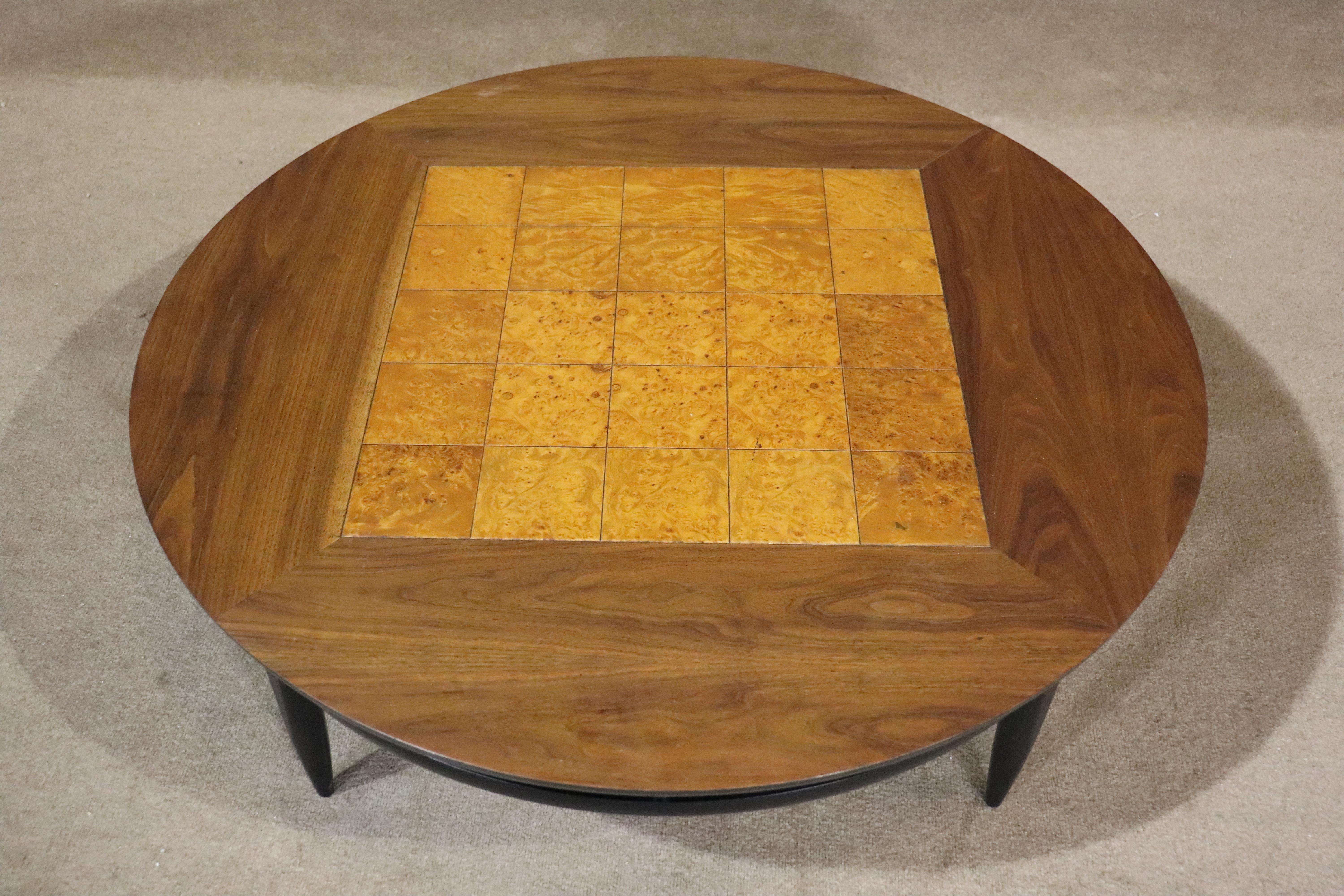 Round mid-century modern style coffee table with inlay burl wood set inside walnut frame, on an ebonized base.
Please confirm location NY or NJ