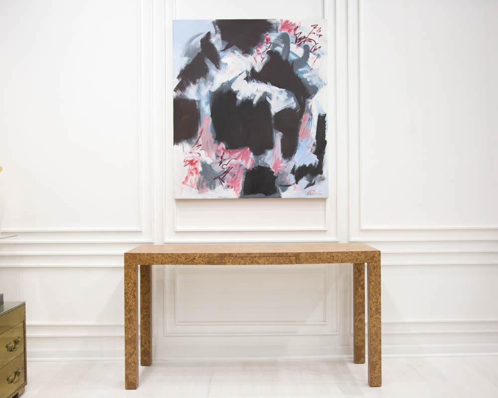 A simple and easy burl effect console table featuring a faux burl finish laminate, a parsons shape frame and one center drawer for storage.

Dimensions: 53.75