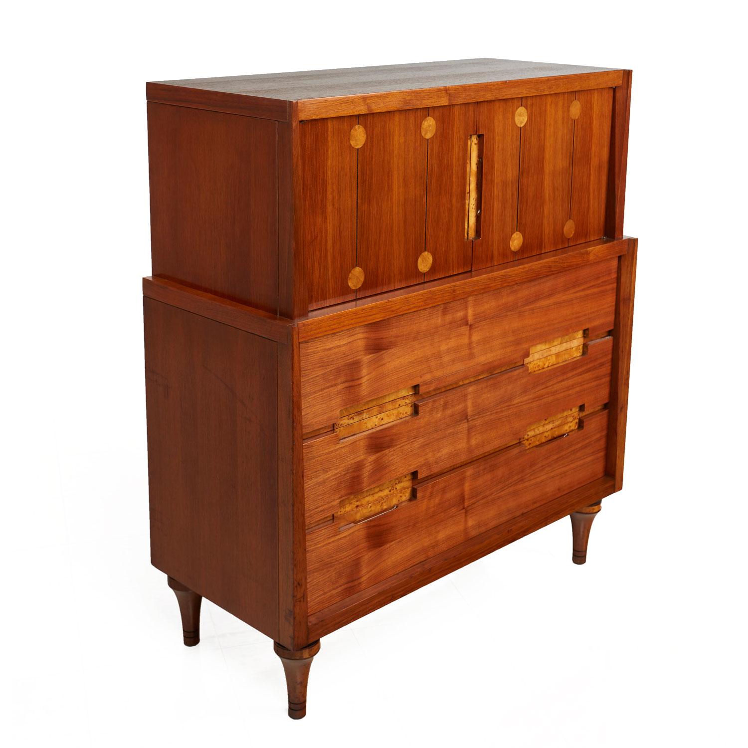 This exquisite highboy dresser / gentleman's chest is as beautiful and rare as it is bizarre. Made in the 1960s by Daniel Jones Inc. of New York. We've never seen a line with such exceptional detail and eclectic design elements. Made from a mix of