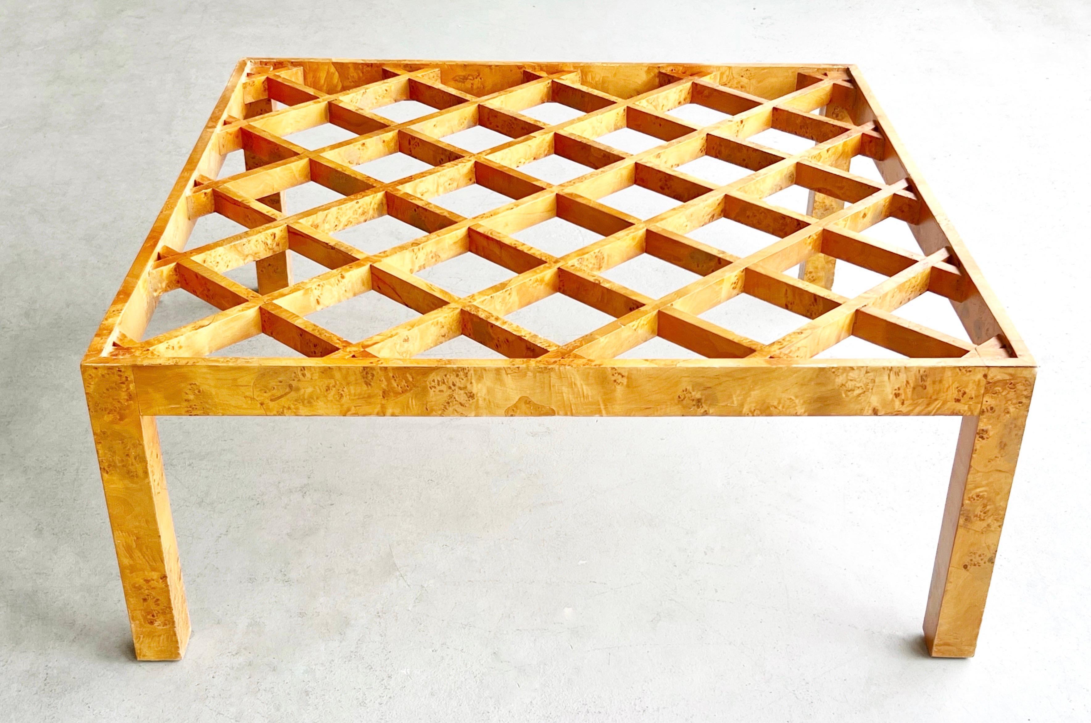 A square Burl coffee table with open lattice design. The simple Parsons style structure creates the perfect frame for the well proportioned trellis design where the glass top sits. 