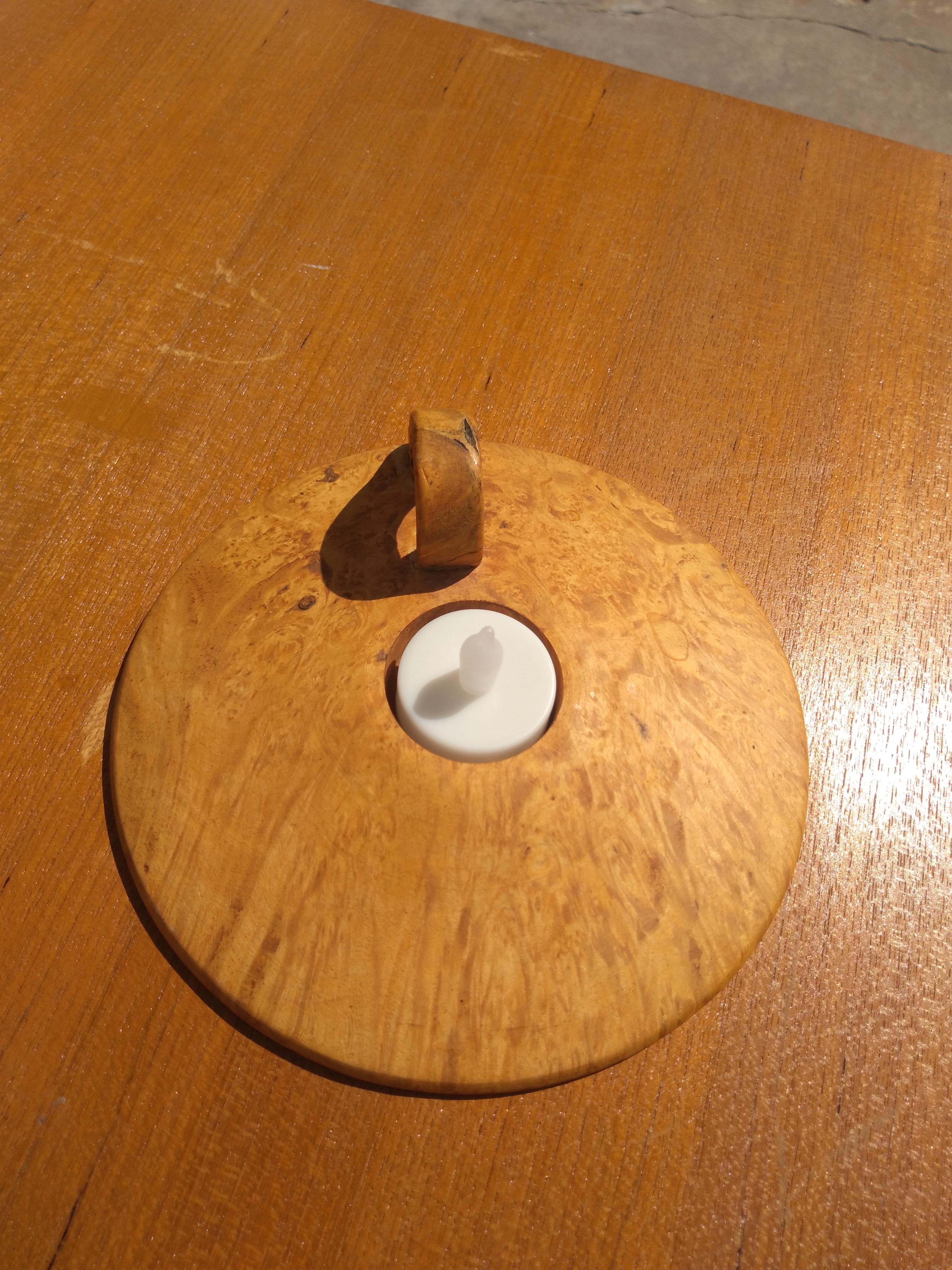 This is a beautifully crafted candleholder. It's made of burl Maple and hand is hand crafted on a lathe. It was made in Iceland.