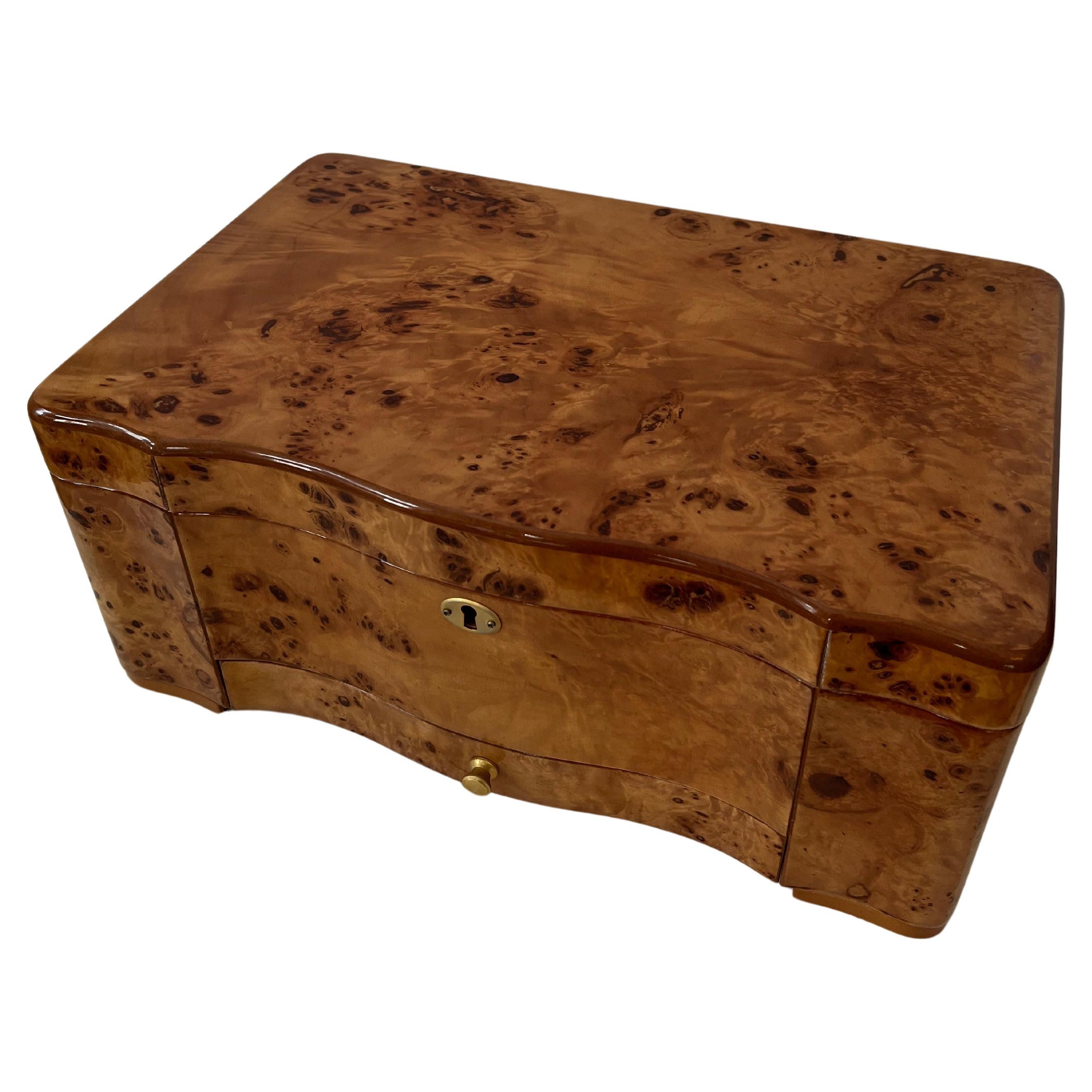 Beautifully detailed Humidor made of Burl Maple.  The finish is high gloss and stunning.   A 1' drawer for accessories, comes with a cigar cutter and box of matches. 

The piece is a would be a compliment to any cigar aficionado for the office,