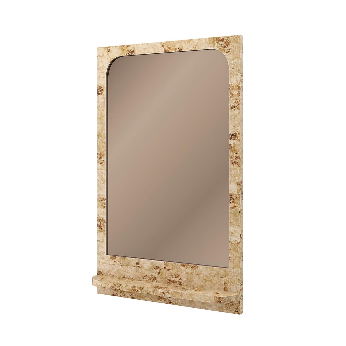 Framed in exotic mappa burl veneers. Tinted bronze casts a warm glow, complemented by a natural interplay of light and dark tones.

Features a small shelf for keeping trinkets and treasures. A standout and unusual modern mirror.

Dimensions: 30
