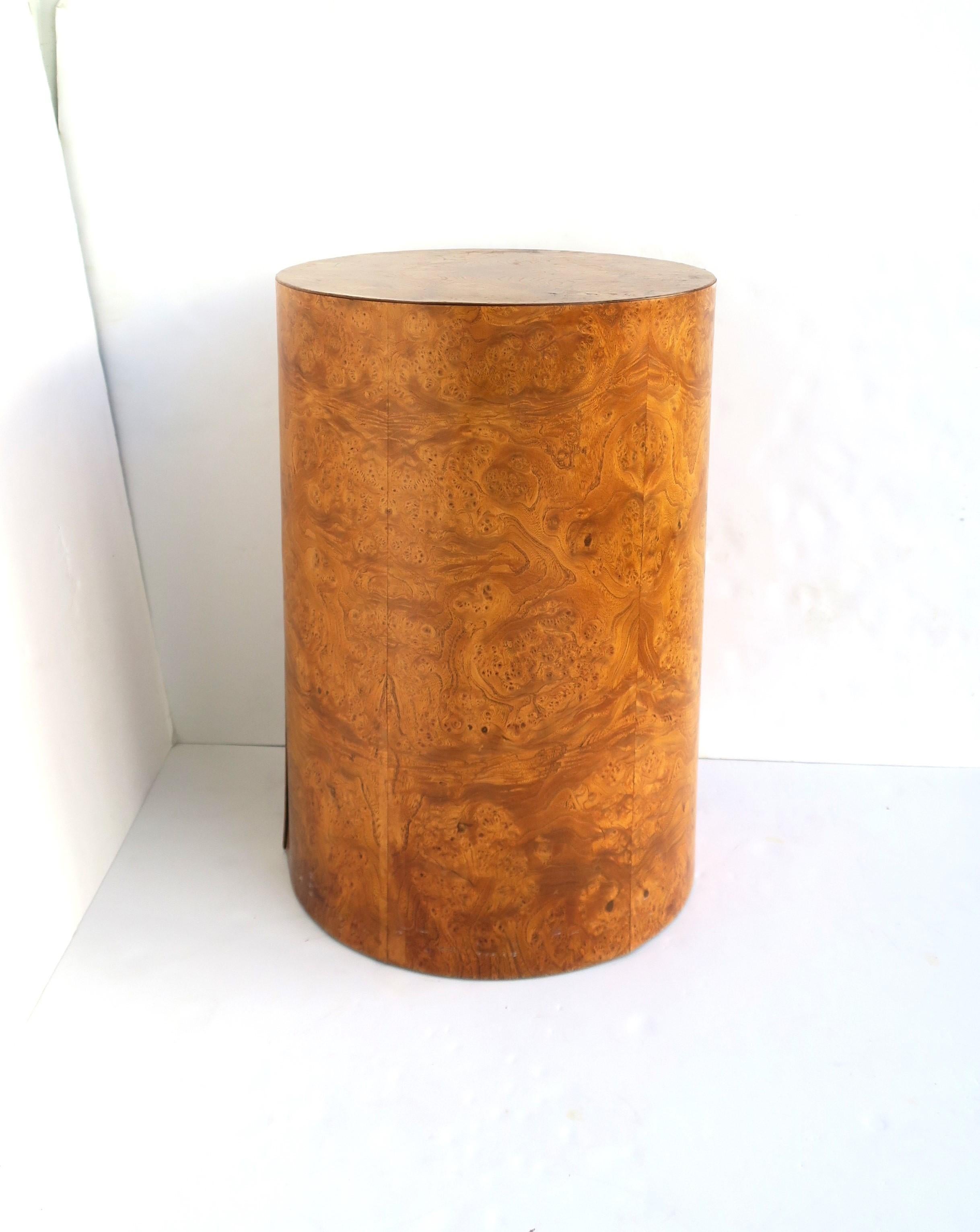 A solid and rich burl pedestal table or column, after designer Milo Baughman, in the modern style, circa mid to late-20th century, 1960s, 1970s. Piece is substantial, covered in a burl wood veneer. A great as a side/drinks table or for sculpture,