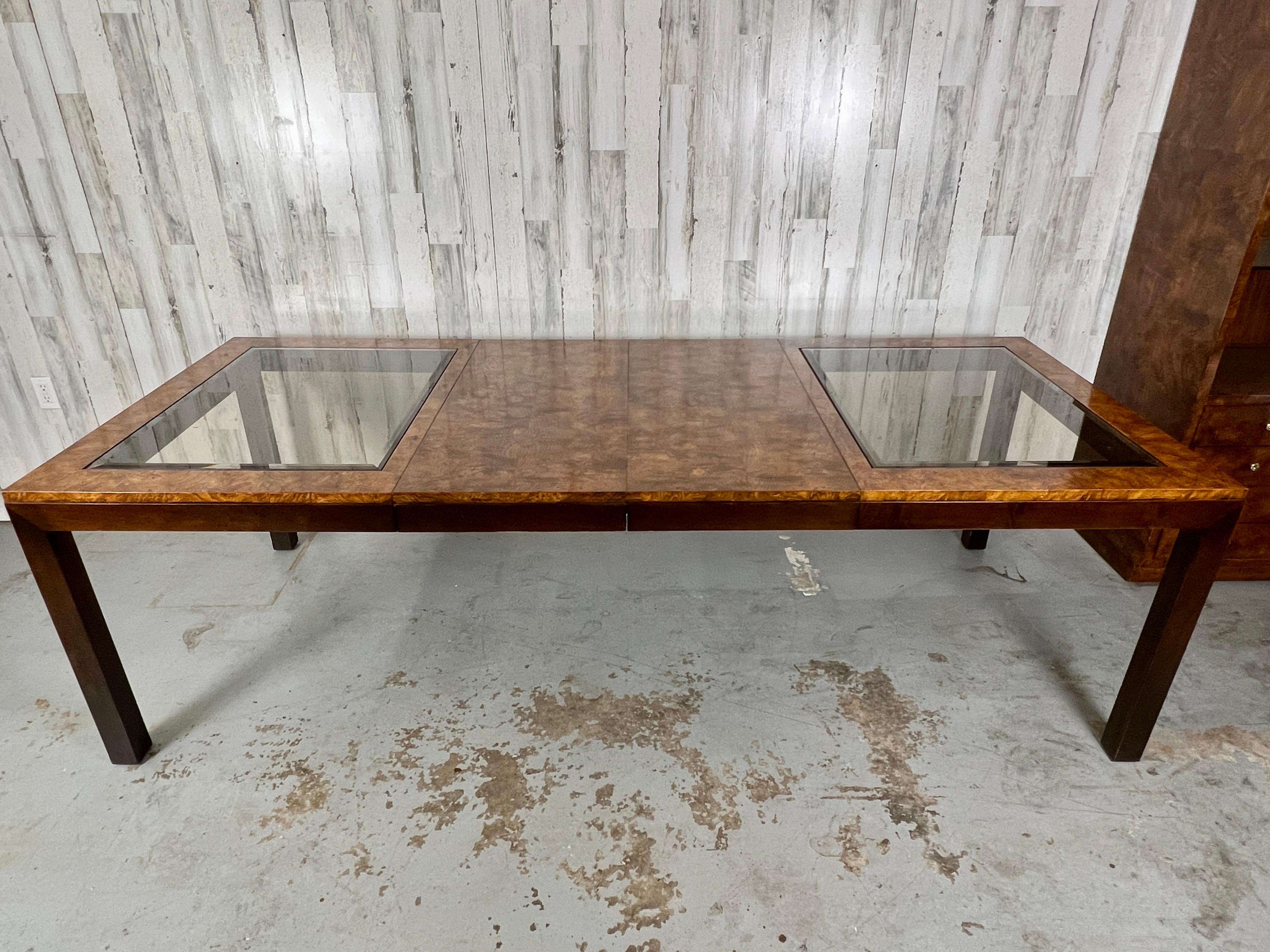 Burl & smoked glass extendable dining table by Century Furniture. This table is a show stopper for someone who loves to entertain lots of guests. Incredible burl wood with smoked glass insets on top. 

Fully extended is 96 L. Each leaf is 18