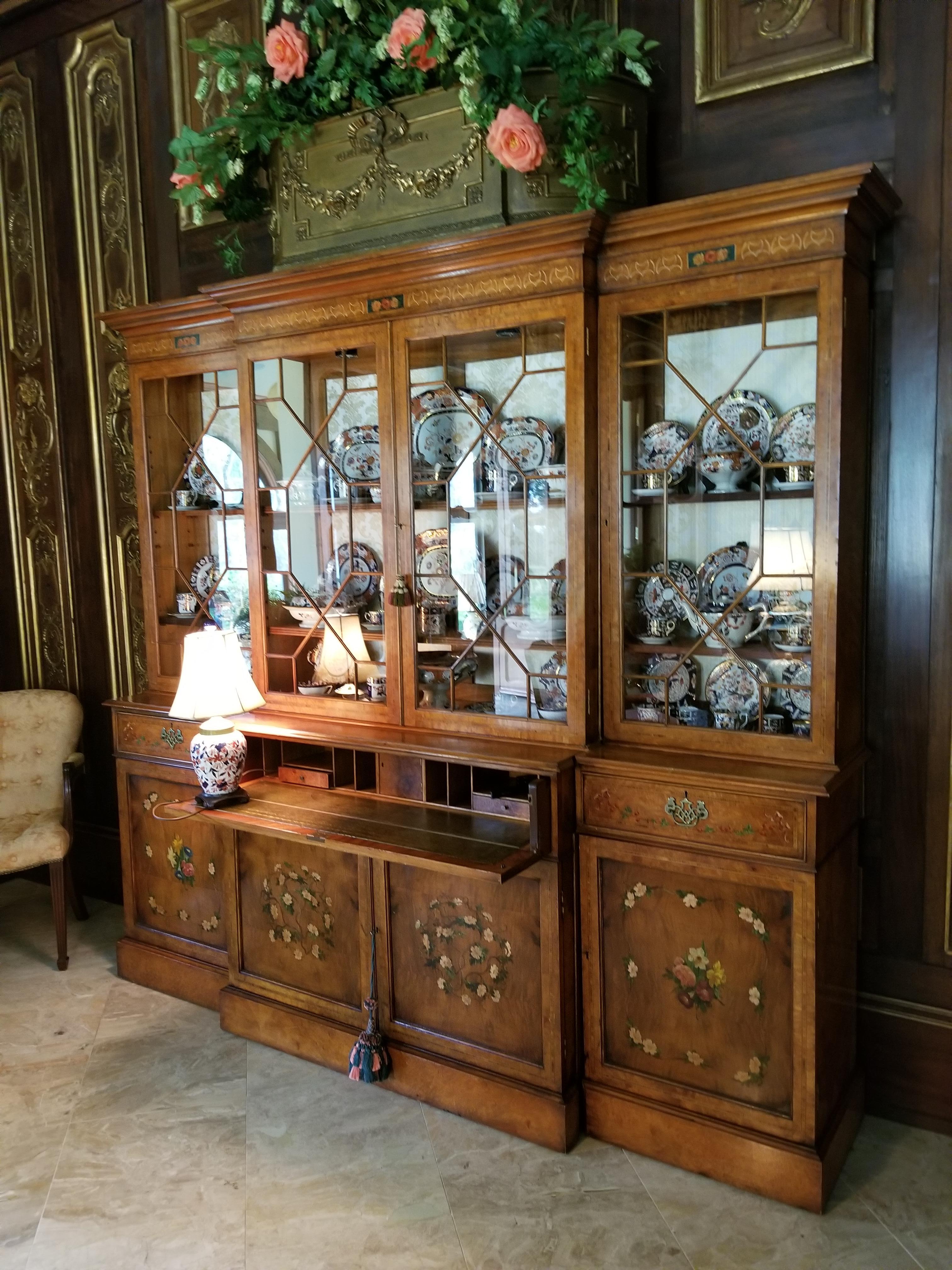 20th century burl walnut breakfront secretary in three sections. Four doors in top section and four doors at bottom section. Pull out secretary and two small drawers. Each glass panel is individually fitted. Each section has a light. All decorative