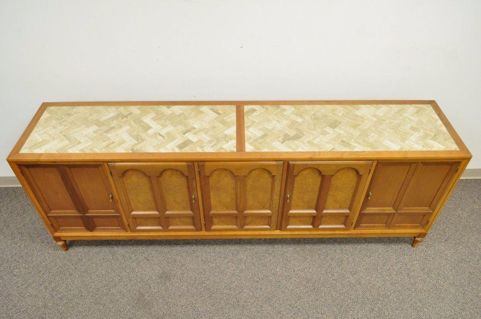 Quality vintage Herringbone Stone inlay, walnut, and cherrywood sideboard cabinet. Maker unconfirmed but believed to be Mastercraft. Item features solid wood construction, stone inlaid top in a chevron / herringbone pattern, four interior drawers,