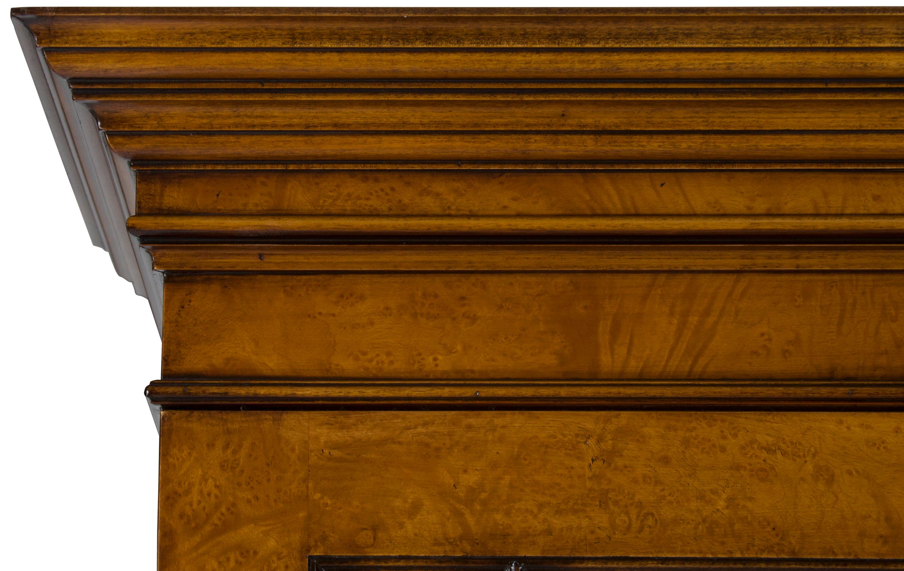This antique style walnut bookcase was recently handmade in England by a third-generation cabinetmaker. From the production process to the materials used, every aspect of this bookcase is of the utmost quality. The burl walnut, for instance, having