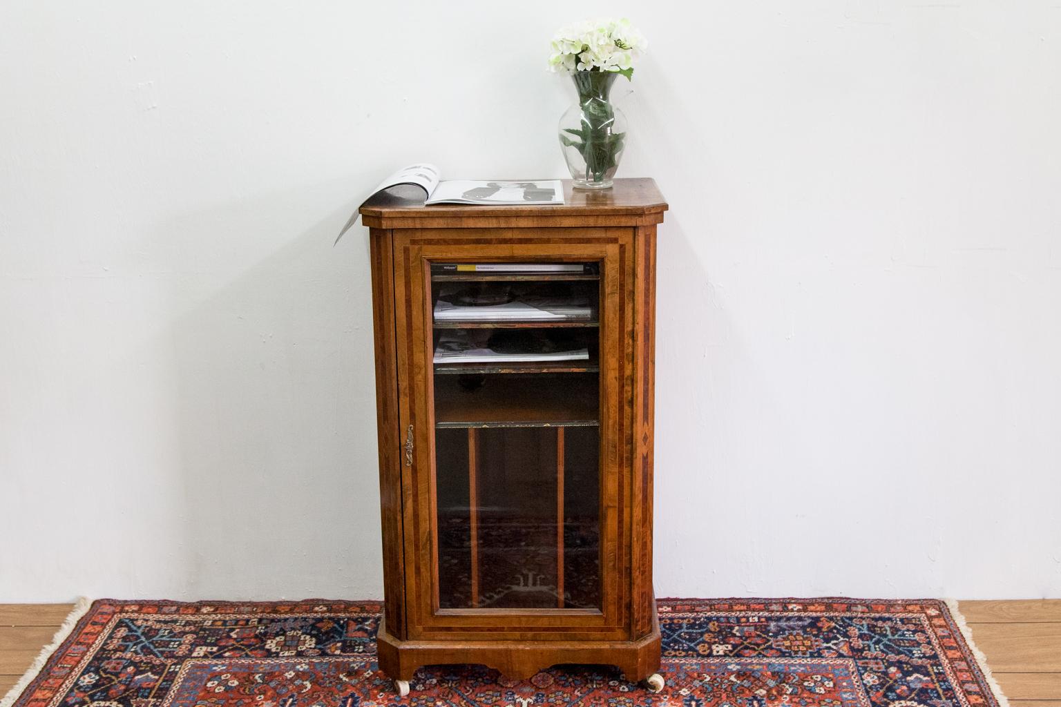 Burl walnut glass door cabinet, the top is crossbanded with bird's-eye maple and boxwood with a beveled top edge. The door has chamfered corners, and the sides have the same wood motif as the top. The inside has four horizontal shelves and three