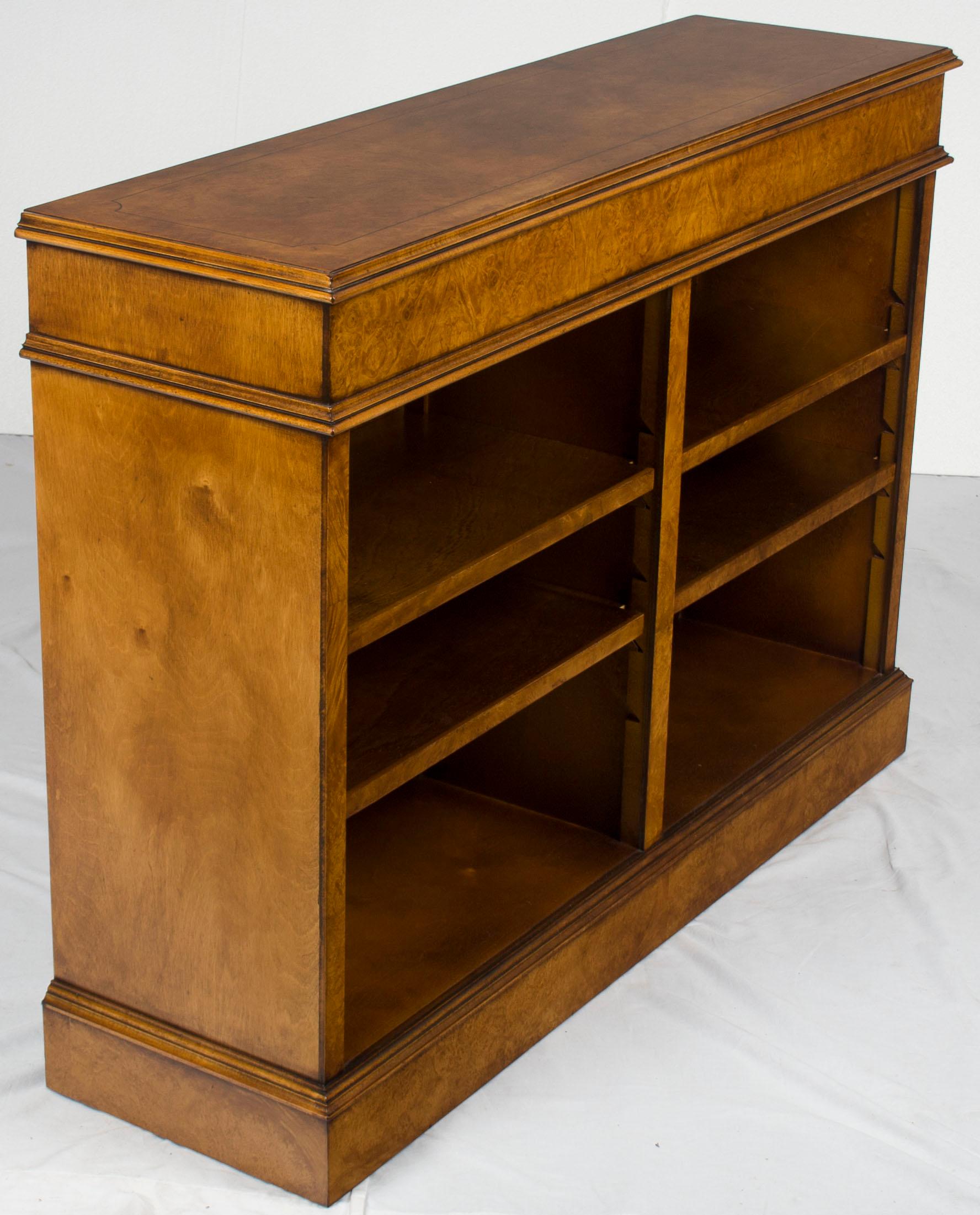 This Classic burl walnut bookcase was recently handcrafted in England as a Georgian period reproduction. The burl walnut was treated to an elaborate finishing process that ended in a Fine coat of hand-rubbed wax, resulting in a rich complexion and a