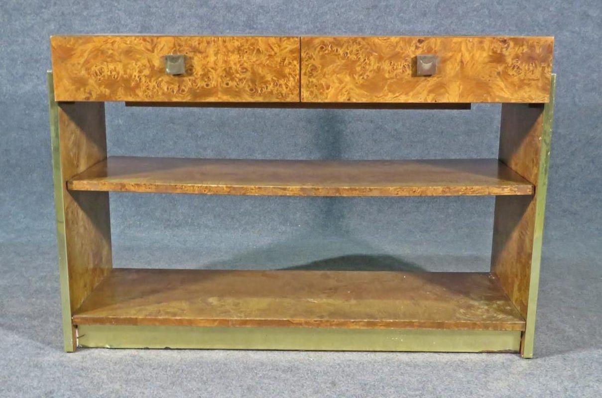 An incredible vintage server showing off a burled walnut woodgrain complemented by square metal handles. With a radiant surface and elegant design, this Mid-Century Modern design styled after Milo Baughman is unique and eye-catching. Please confirm