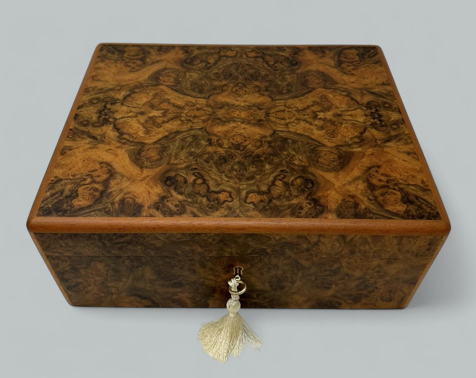 Absolutely Stunning Ladys or Gentlemans Jewellery Casket of outstanding quality and of generous size, made in Ireland by renowned cabinet makers Mannings of Ireland, using well figured Burl Walnut  
This box is constructed of the finest woods