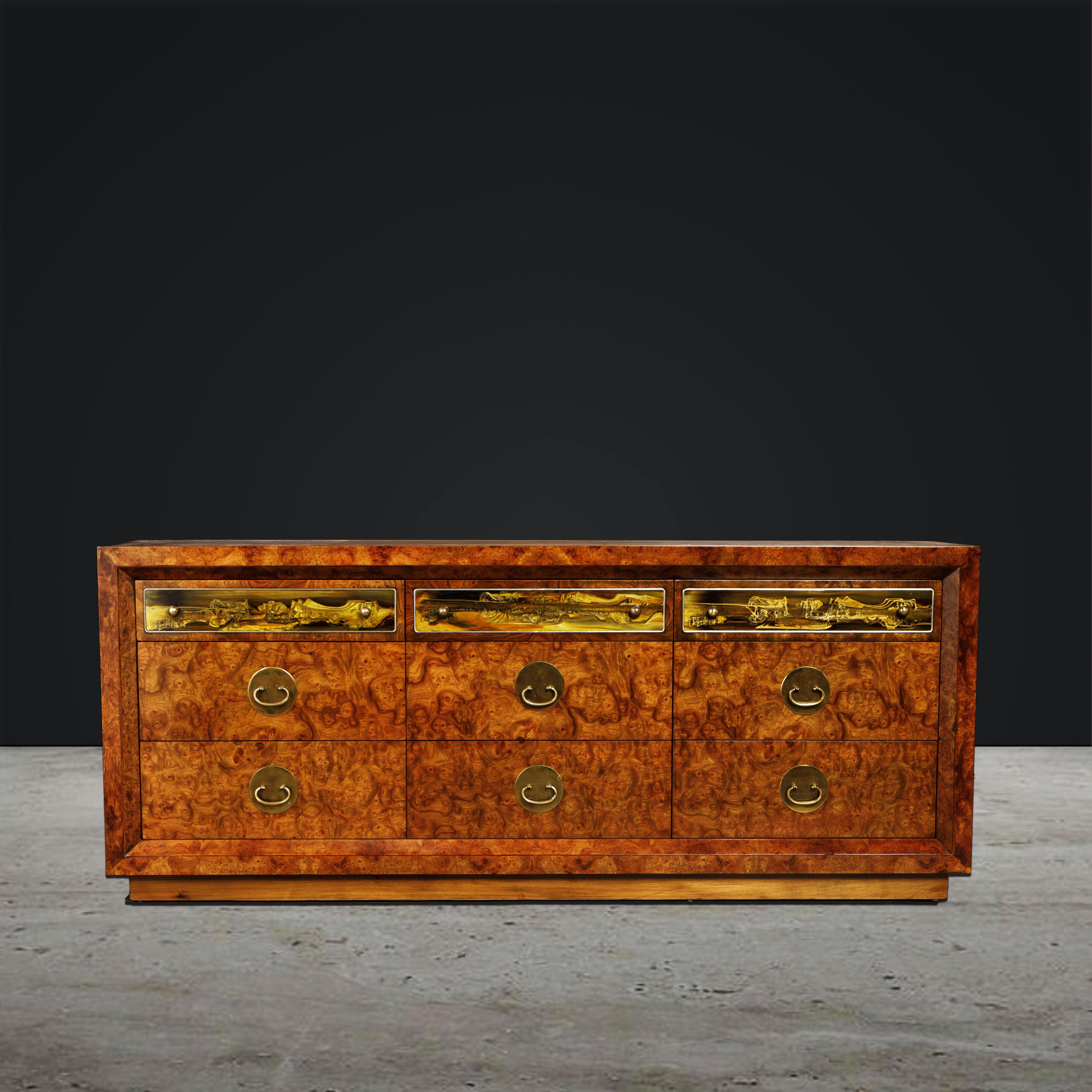 This newly refinished 9-drawer burlwood dresser by Bernhard Rohne for Mastercraft is simply incredible, from the striking deep grained burl to its refined brass pulls and mesmerizing acid-etched art panels - this is the perfect finishing piece for a