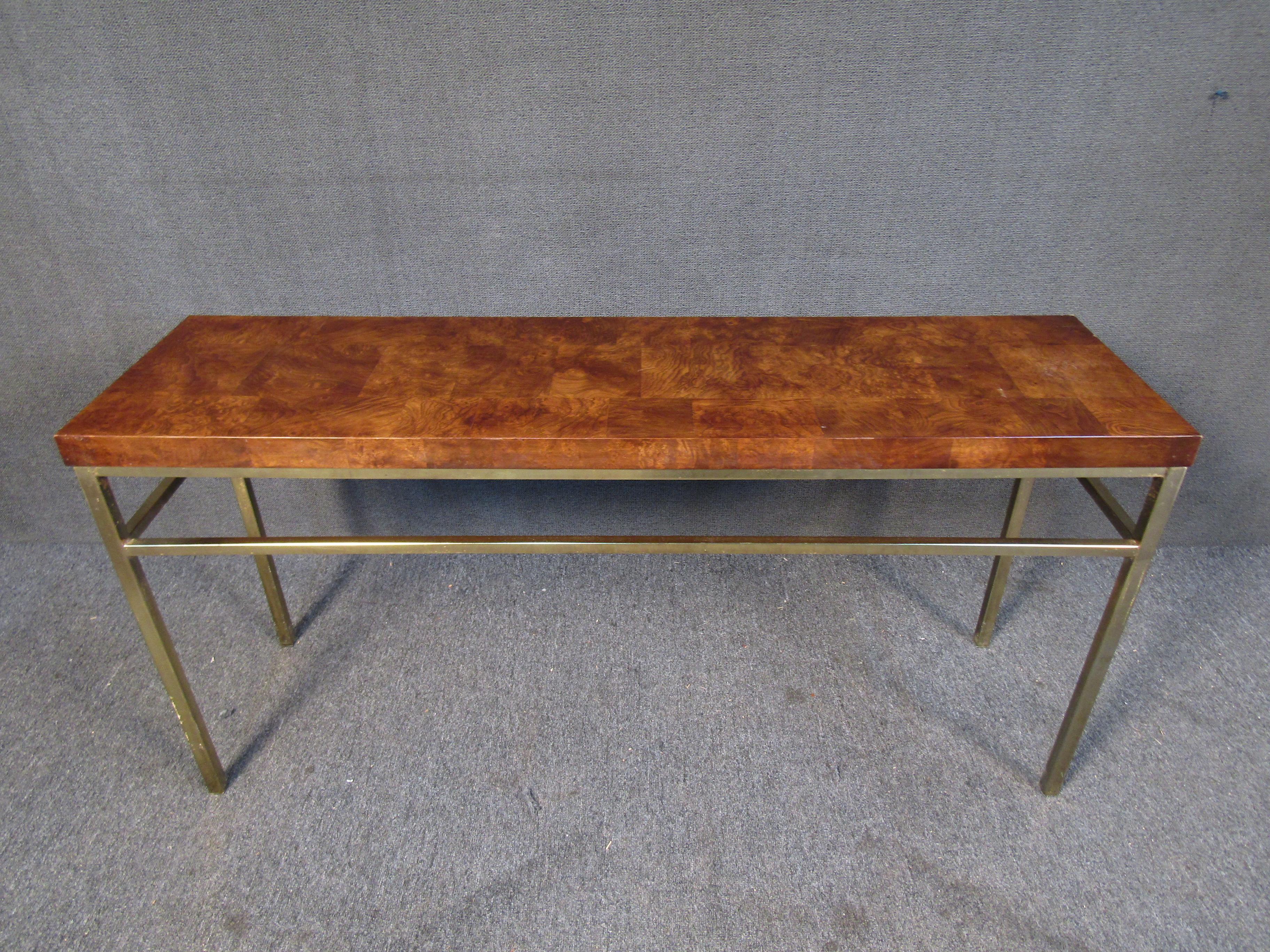 With a unique surface using contrasting squares of burl wood, this Mid-Century Modern console table features an interesting base of metal with a yellowish golden tint. Please confirm item location with seller (NY/NJ).