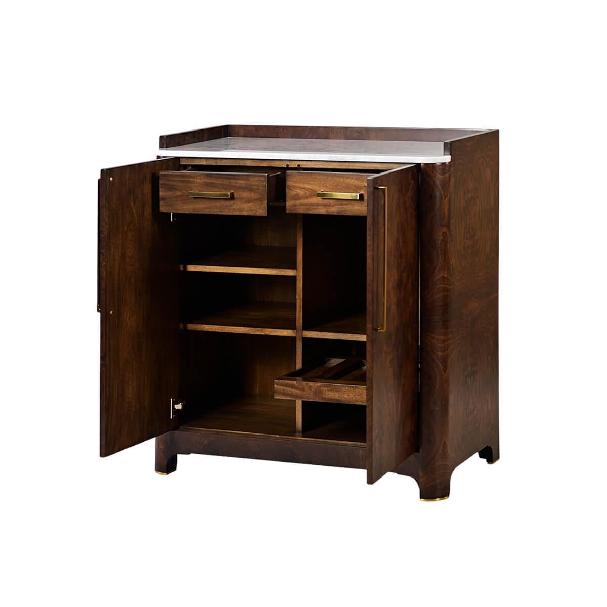 A classicly inspired modern bar cabinet with an inset marble top and a three-quarter gallery. With a figured burl walnut exterior, curved corners, a shaped apron, brass brass-finished plate feet.


It has two smooth doors with long brass rod pulls.