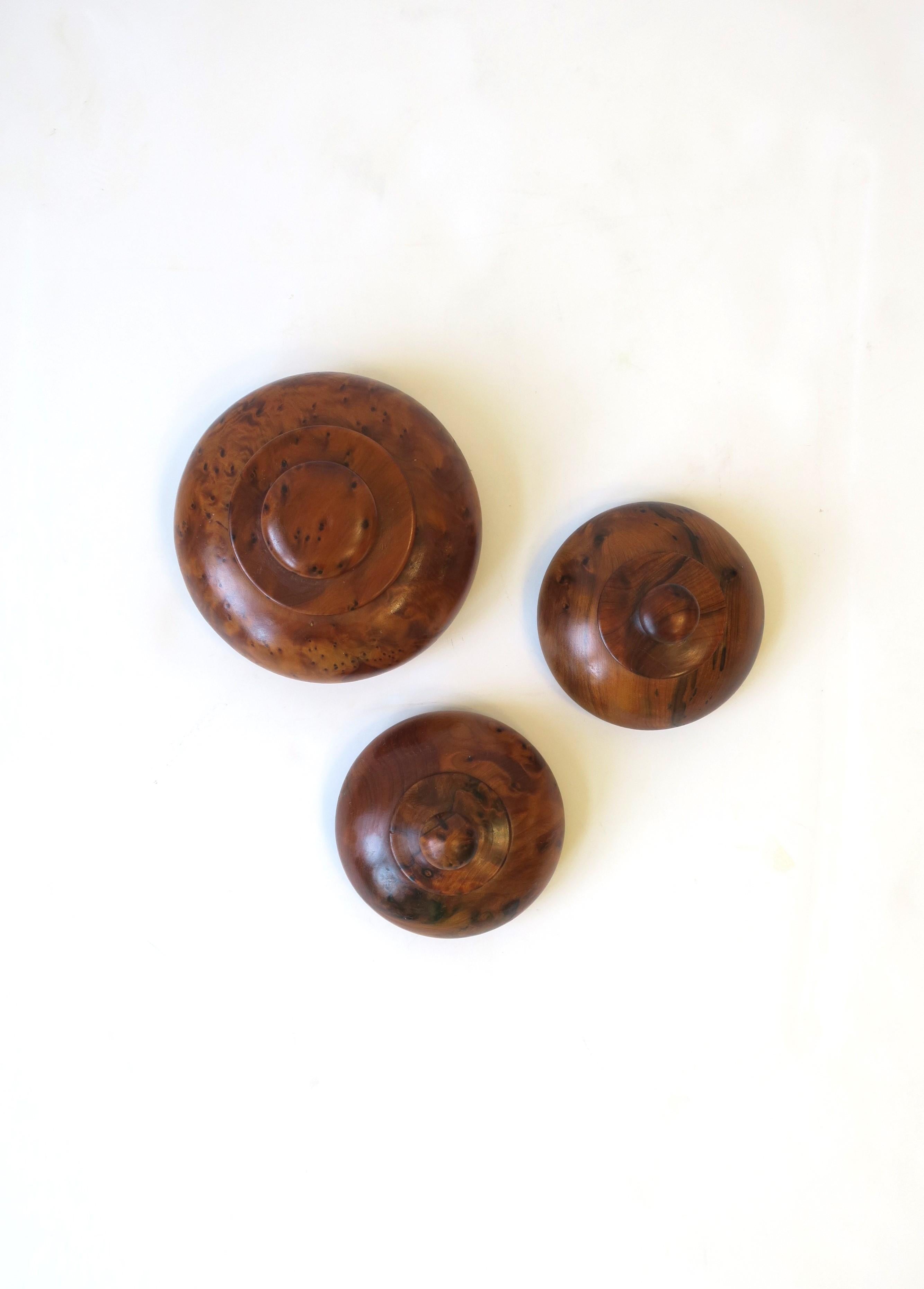 A set of three (3) round burl wood boxes with lids. A great set to hold items on a desk, vanity, nightstand table, dresser, etc. 

Dimensions: 
4.5