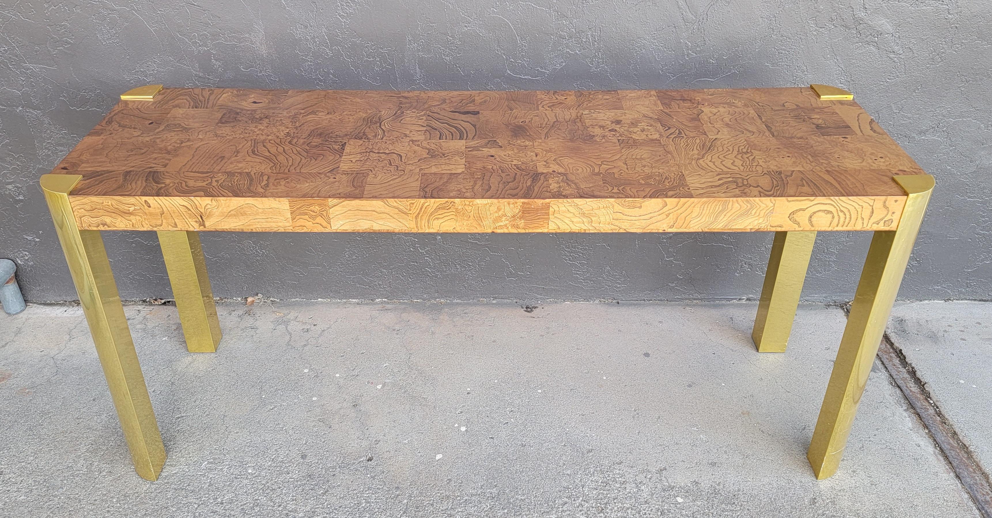 Patchwork Mid-Century Modern / Hollywood Regency console table attributed to Milo Baughman. Possibly inspired by the designs of Paul Evans. Beautiful burl wood tile surface and aprons mounted to brass legs. Measures 57 inches wide.