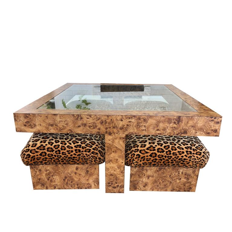 Square veneered burl wood cocktail or coffee table with glass. Four matching ottomans or poufs which slide under each of the parsons style legs. Stools are covered in a velvet animal print reminiscent of Scalamandre's Tiger print. Wonderful vintage