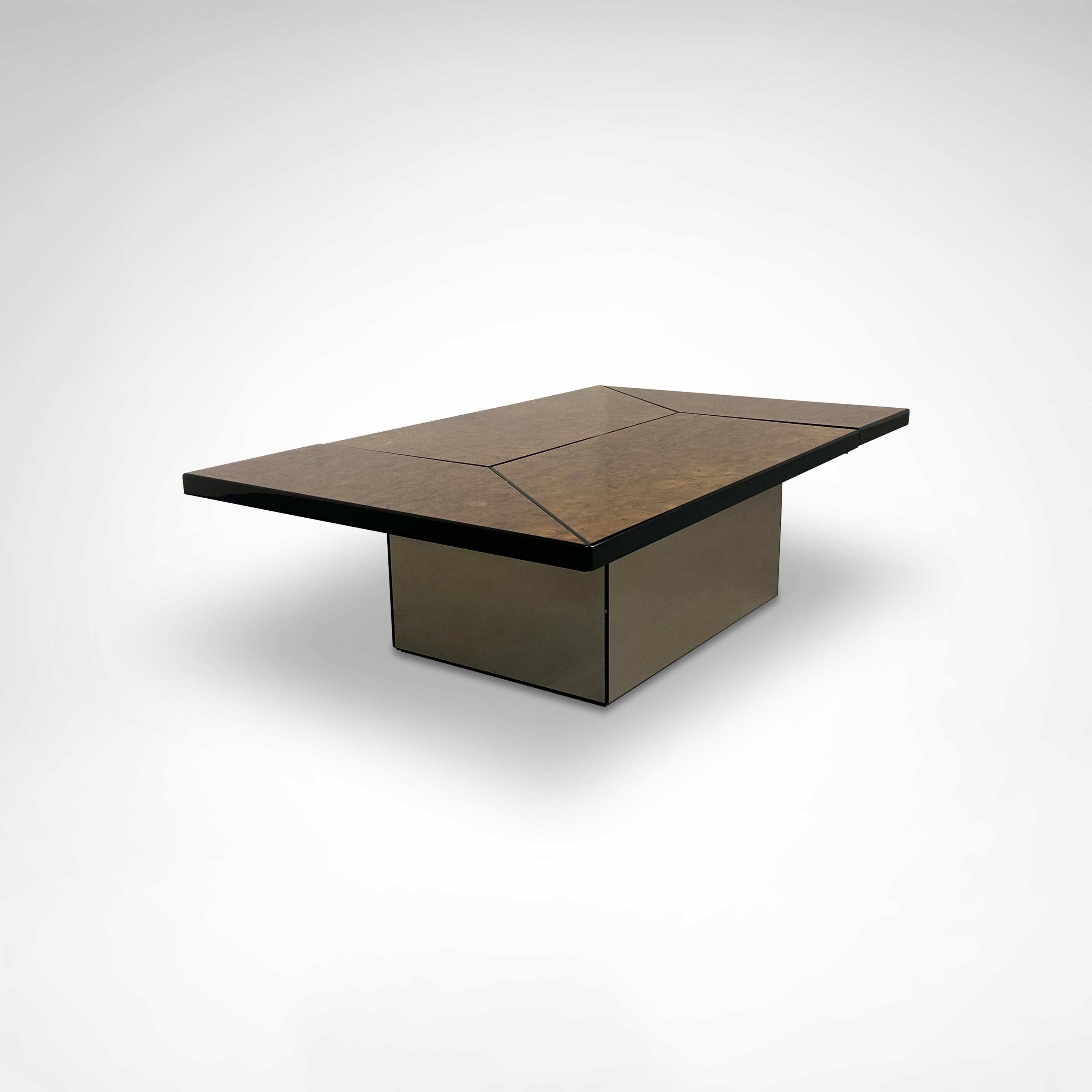 Super sophisticated stunning coffee table designed and manufactured by Paul Michel, France 1980s.

This metamorphic coffee table is cleverly designed and slides smoothly open to reveal a mirrored spacious looking dry bar compartment, perfect spot to