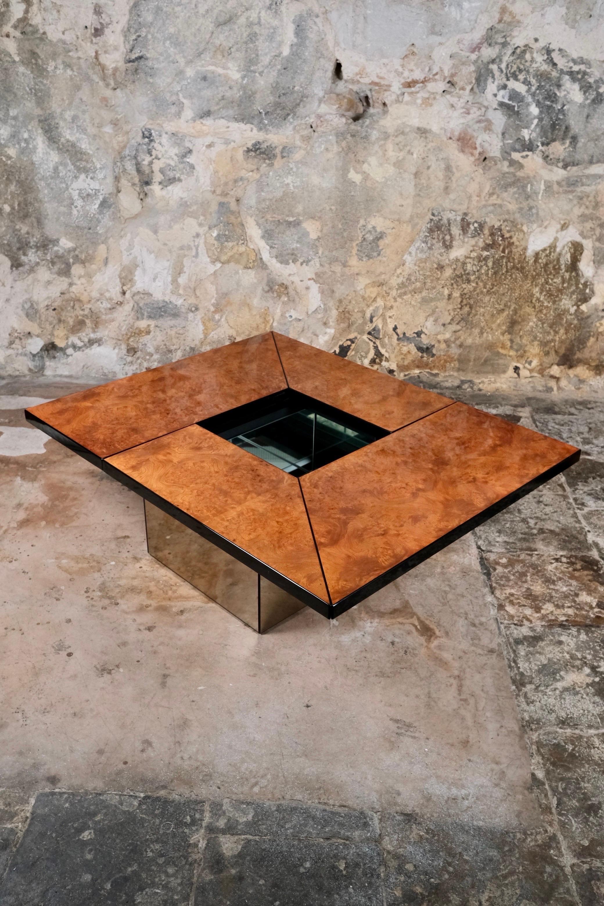 Gorgeous sliding coffee table with a full mirrored bar, designed by Paul Michel for Roche Bobois, France, in the 1980s.
Central feet covered with smoked and lightly pink toned mirrors, sliding top in elm burl wood, lacquered.
Bar with a glass shelf