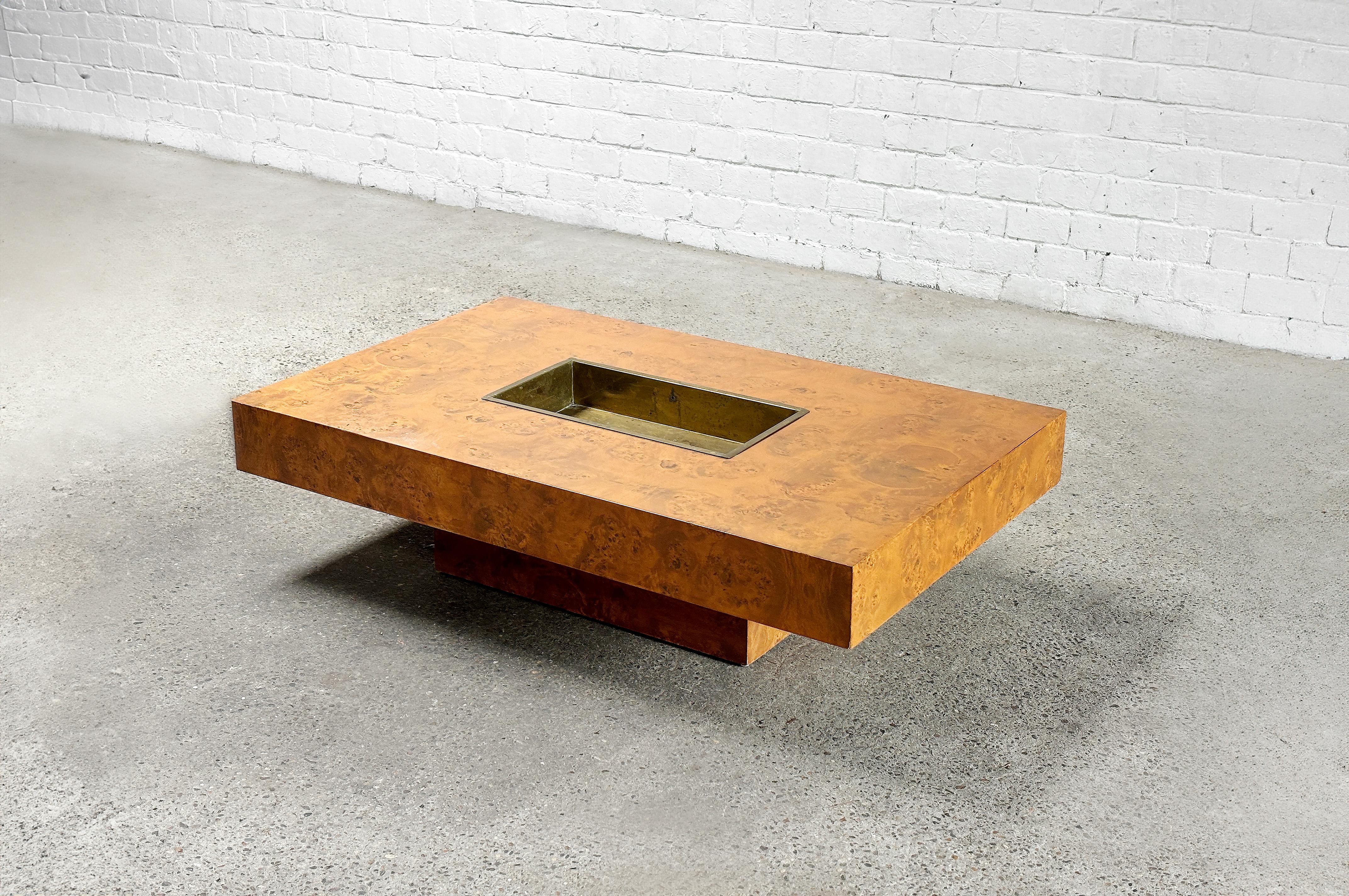 Rectangular Burl Wood coffee table designed and signed by Jean Charles for Maison Charles in the 1970's. This table is a refined tribute to the opulent ambiance of 1970s high-society glamour. Highlighted by a central brass tray, this piece offers