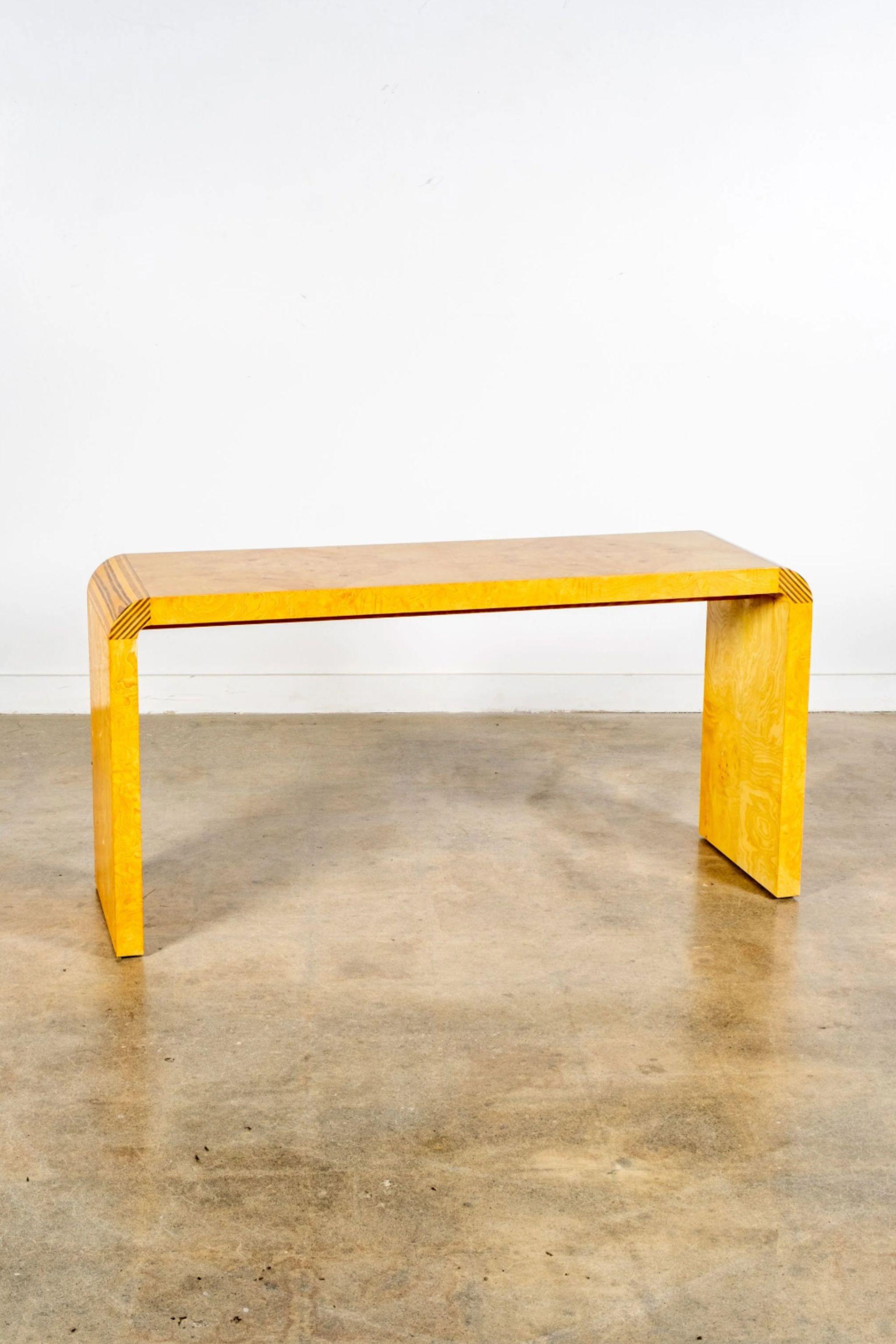 Glossy and refined burl wood console table, its familiar form made less predictable with beveled corners that interrupt the swirling pattern of the grain. A smart addition to an entryway or other transitional space.