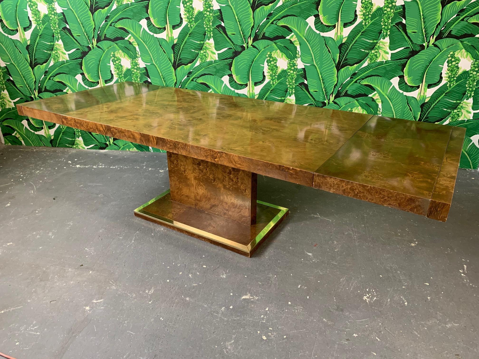 Burled elmwood dining table by Founders furniture for Thomasville, circa 1975. Includes two leaves, full table pads, and protective leaf storage covers. Each leaf measures 16.25