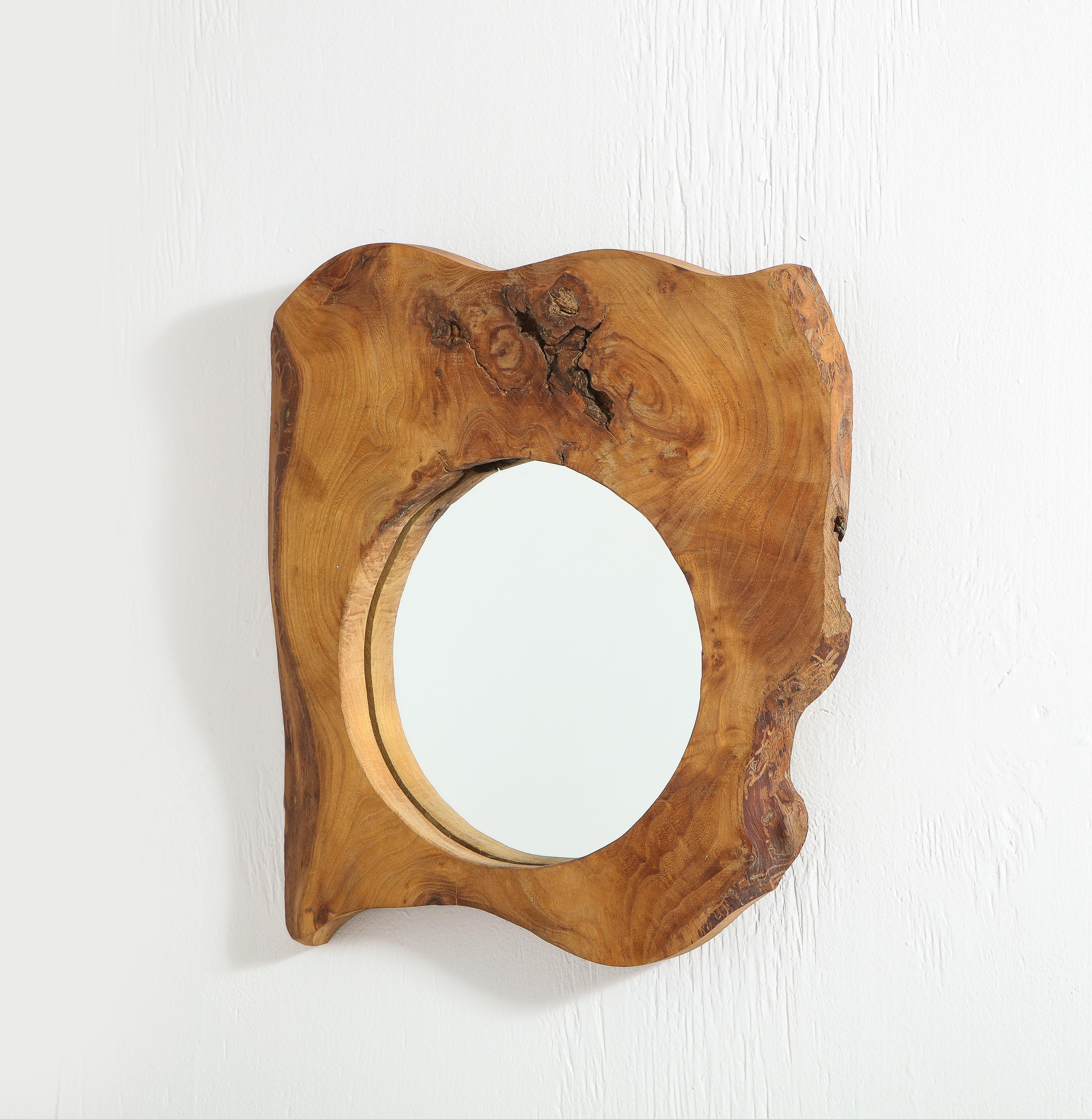 Mirror carved out of solid burl wood.