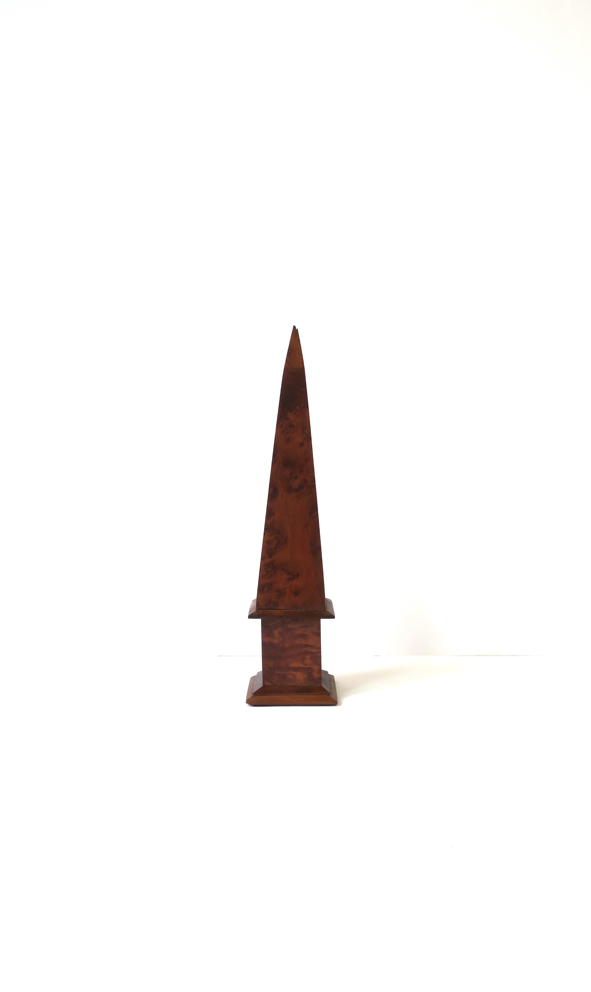 A brown burl wood obelisk, circa early-20th century, England. Obelisk is hand-crafted in a rich brown burl. A beautiful decorative object for a bookshelf, office, desk, etc. Dimensions: 12.32