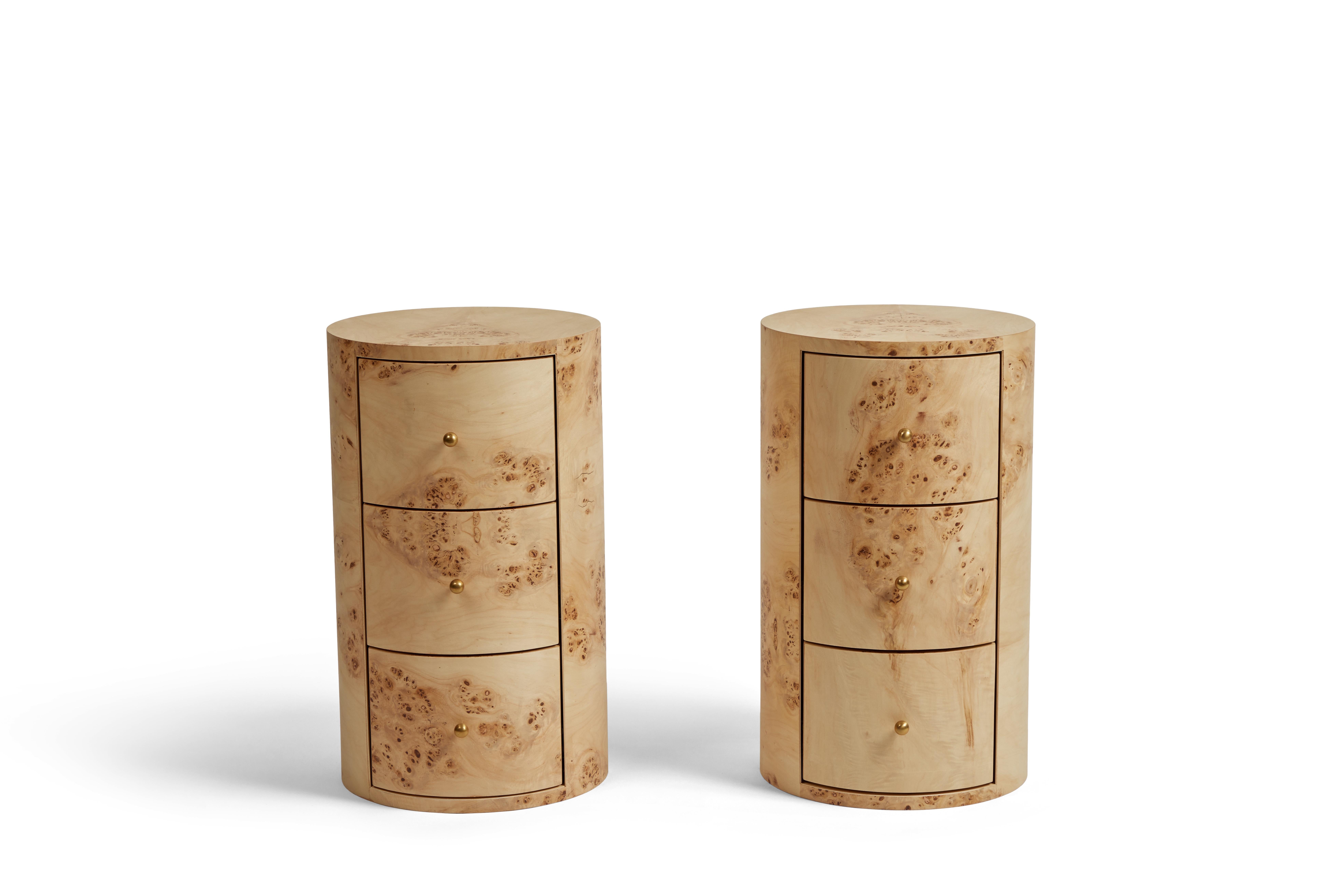 This cylindrical side table features a beautiful burl wood veneer that adds natural and organic texture to any space. The tables feature three drawers with petite aged unlacquered brass knobs. Use as a side table or nightstand. 
 
DIMENSIONS: 14
