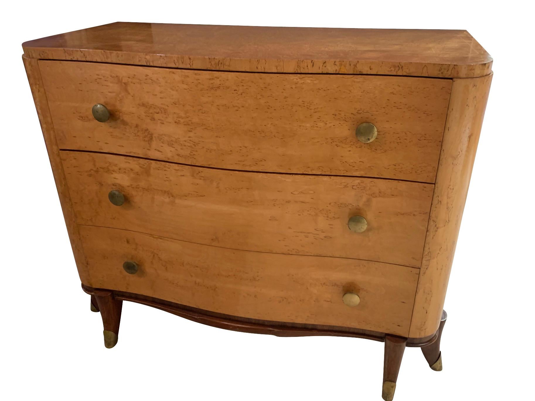 1930's French burled wood three drawer commode.
In the style of Jules Leleu.
Brass button style knobs.
Very unusual and decorative splayed front legs.
All with brass sabots.