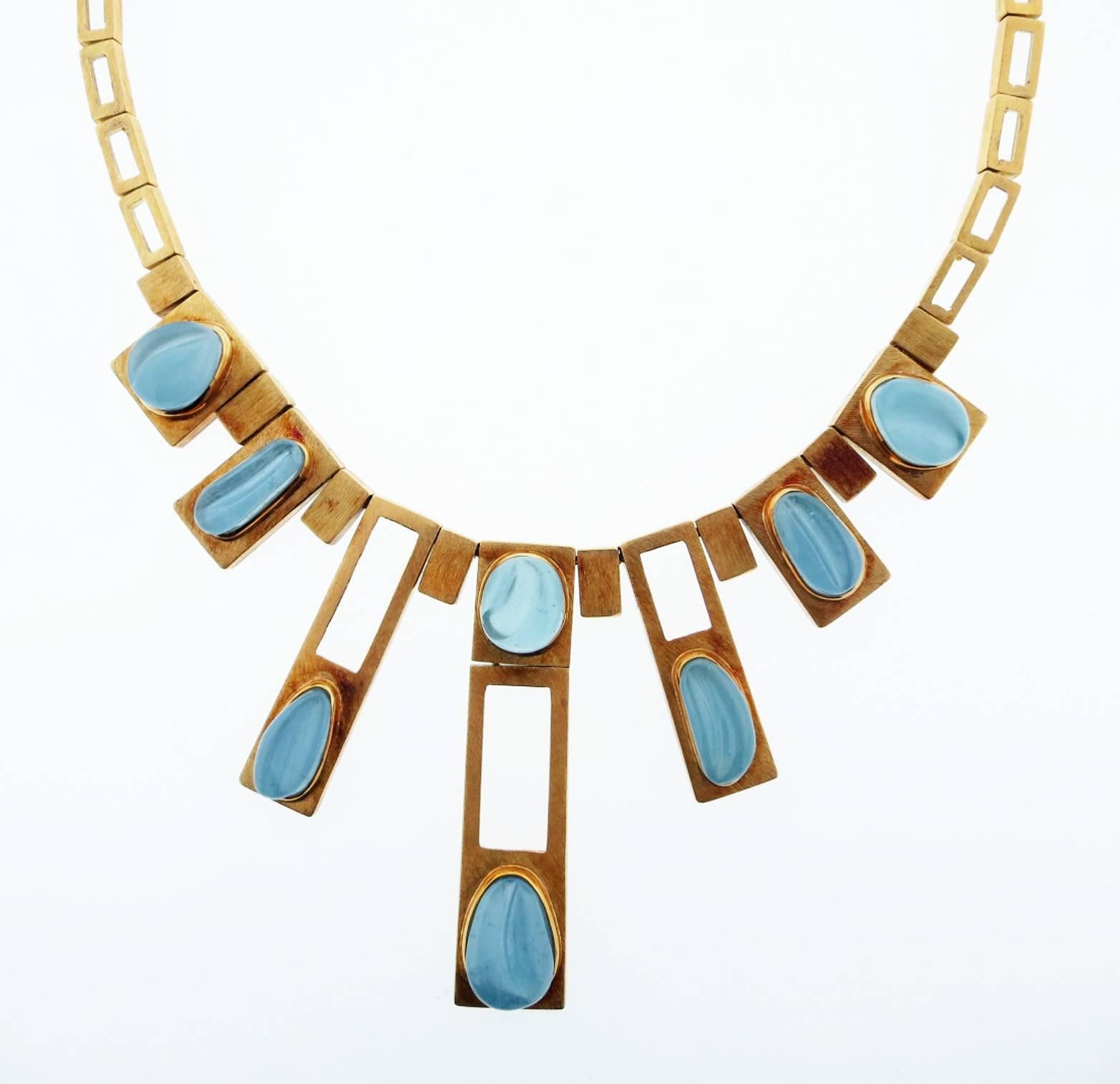 Fabulous modernist design necklace made by the re-nowned Brazilian artisan jeweler Burle Marx circa 1970. The textured finish 18kt.  yellow gold geometric necklace measures 16 inches in length and is set with nine carved natural aquamarines.