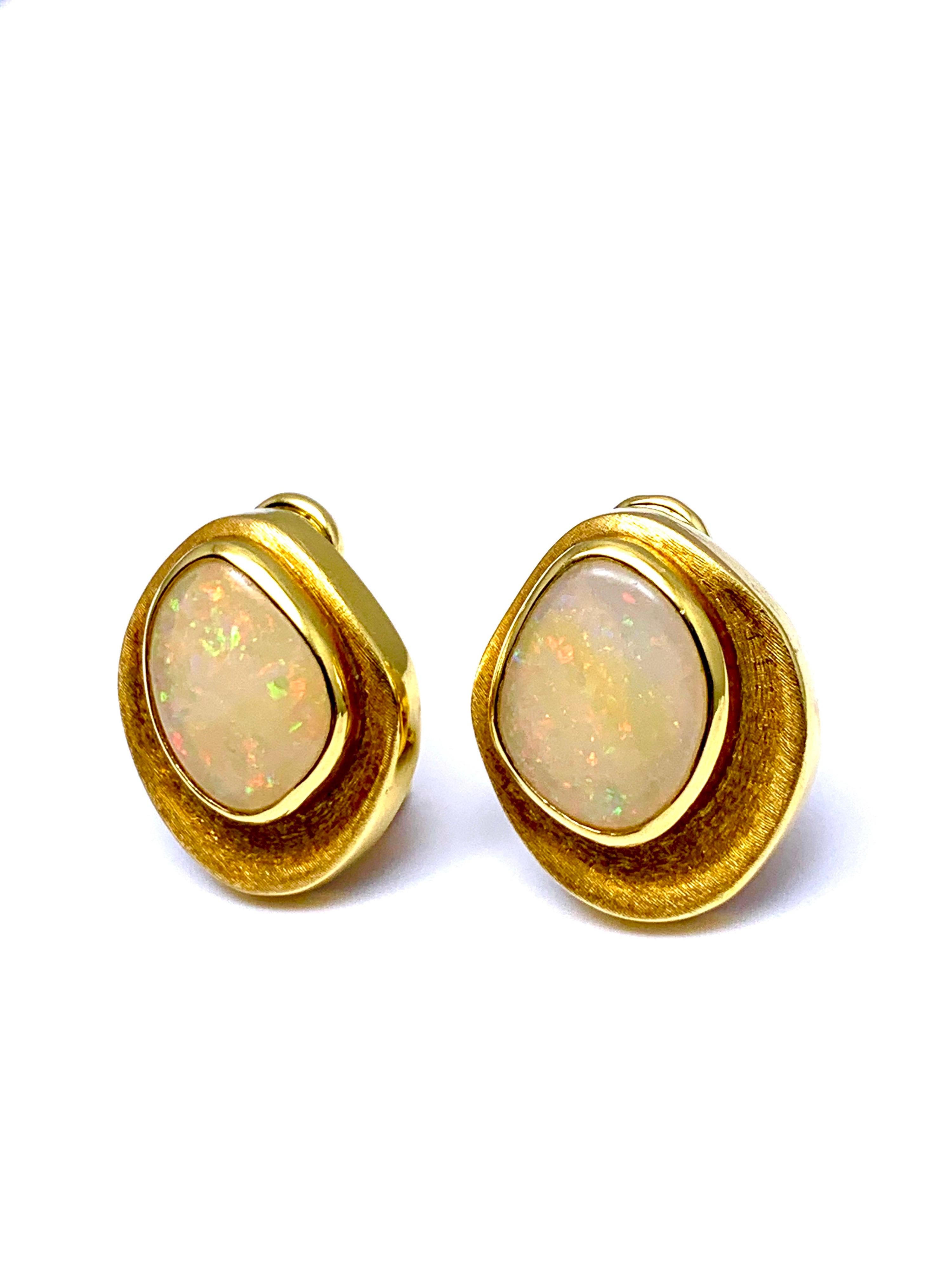 A beautiful White Opal earrings designed by Burle Marx. The 5.97 carat cabochon opals displays a wonderful play of color, bezel set in an 18 karat yellow gold abstarct design earrings. The backs of the earrings are signed 