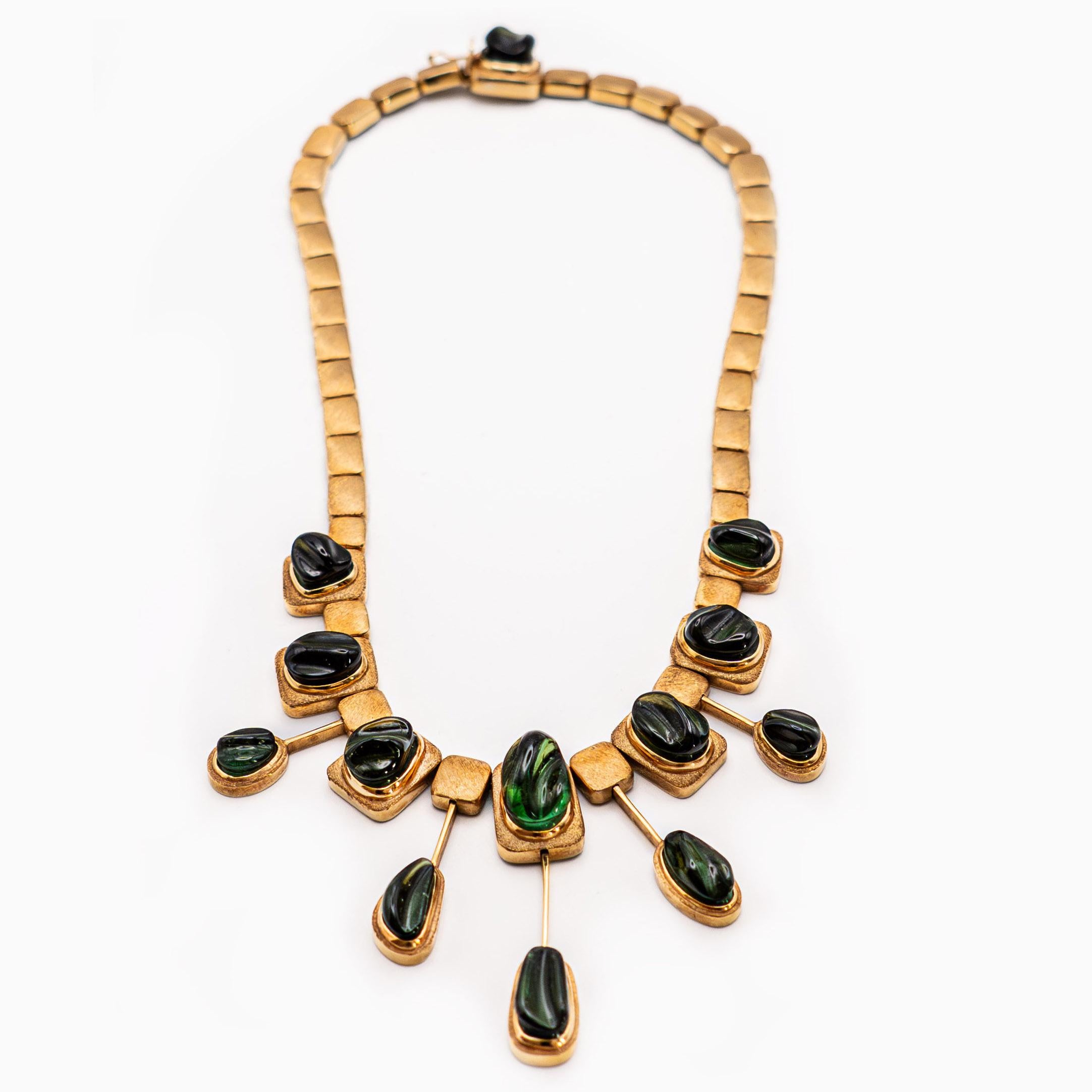 Description: An extraordinary modernist fringe necklace Forma Livre Carved Green Necklace -Handmade- Green Tourmalines, 18K Gold. Weight: 81.2 gr. Approximate Total Gemstone Weight: 57.58 cts. Circa: 1965

The tourmalines in this necklace are of the