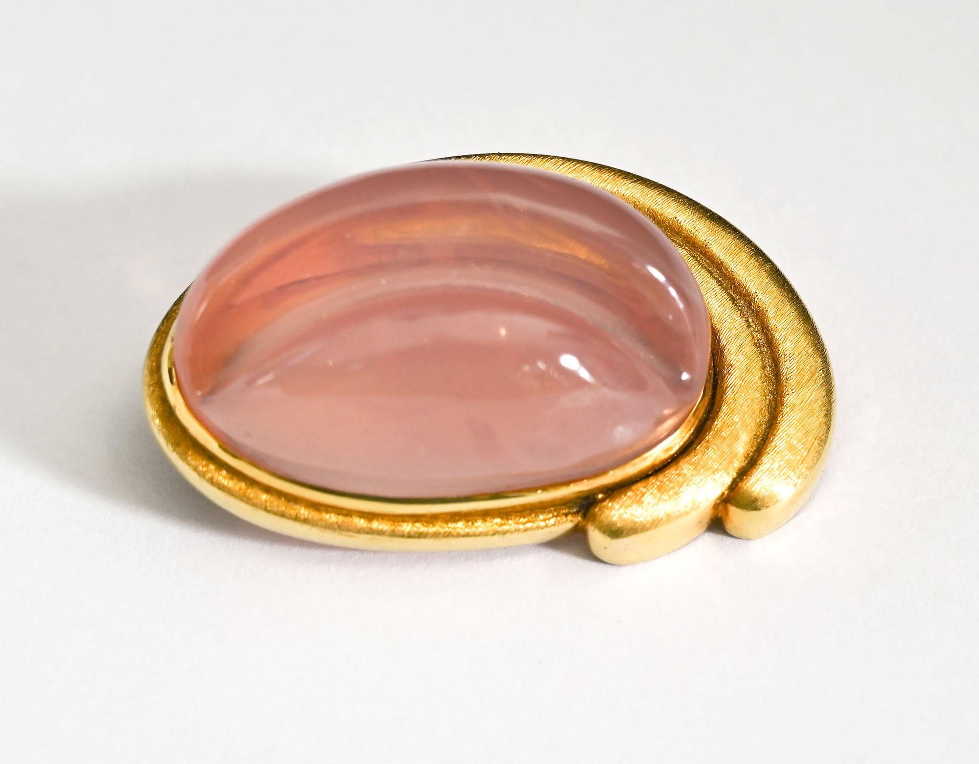 Rose quartz is set in  18 karat gold in this brooch by Roberto Burle Marx, Brazil's most well known jeweler.
The oval stone is cut in the forma livre, or free  form style he often favored.. The gold has a slightly brushed  finish. The brooch has a