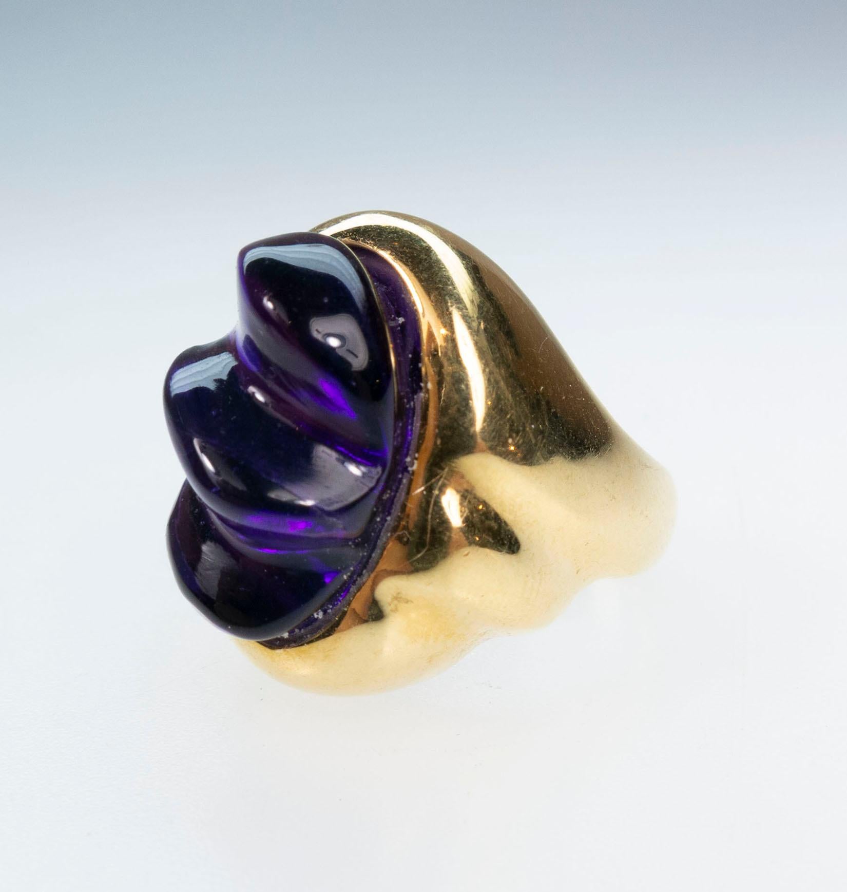 Secrett  18K Amethyst Ring, C.1970. The forma livre deep purple amethyst gauging approximately 17.00 x 11.50mm x in polished gold setting following contours of amethyst swirl, plain shank stamped 18K Secrett. Ring Size: 6.25. Total Item Weight: