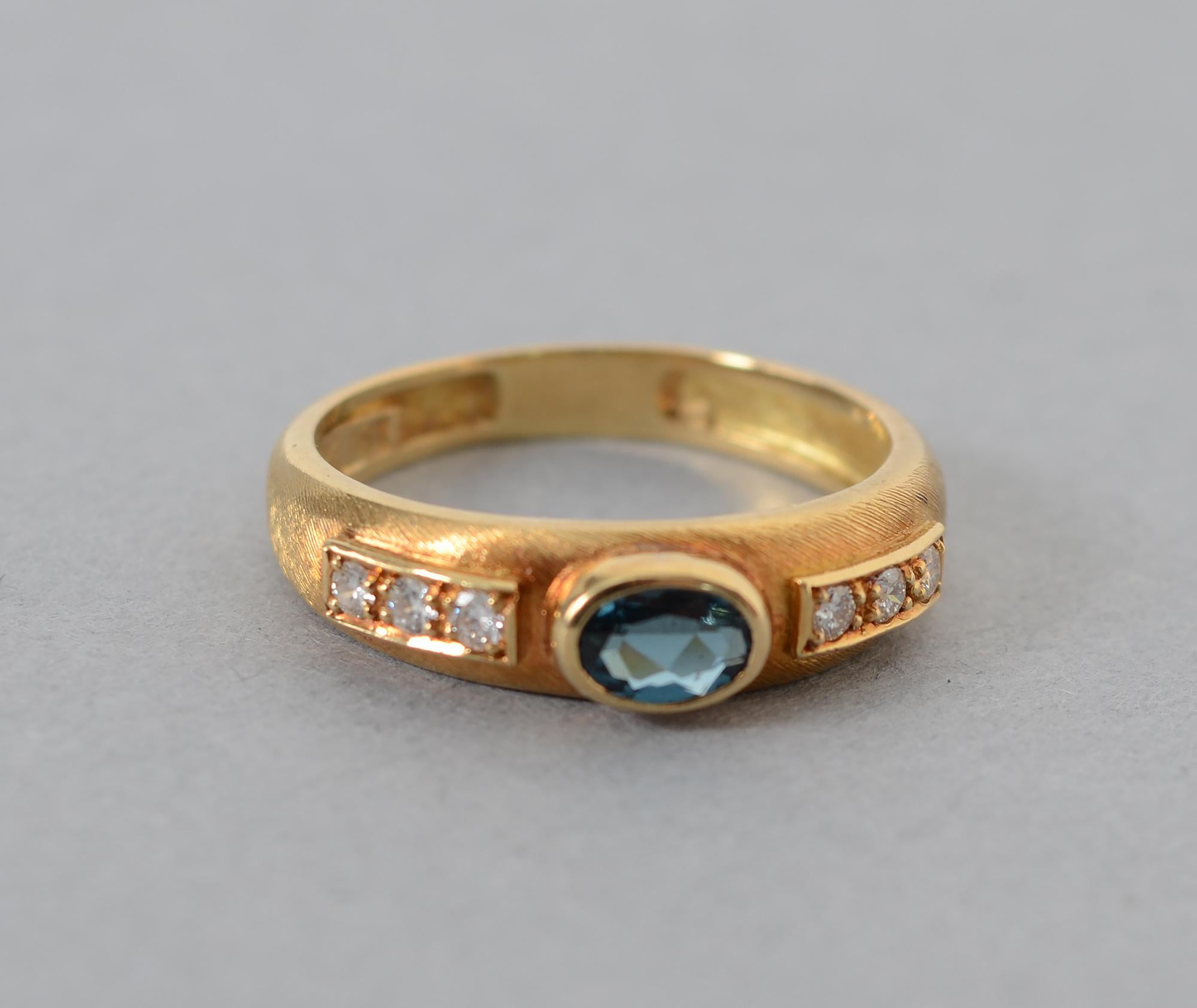 Delicate Burle Marx 18 karat gold ring centered with an oval blue topaz stone and flanked by three diamonds on each side. The ring has the lightly brushed finish often seen in Marx's work.
The ring is size 8 and can be sized up or down.
It is