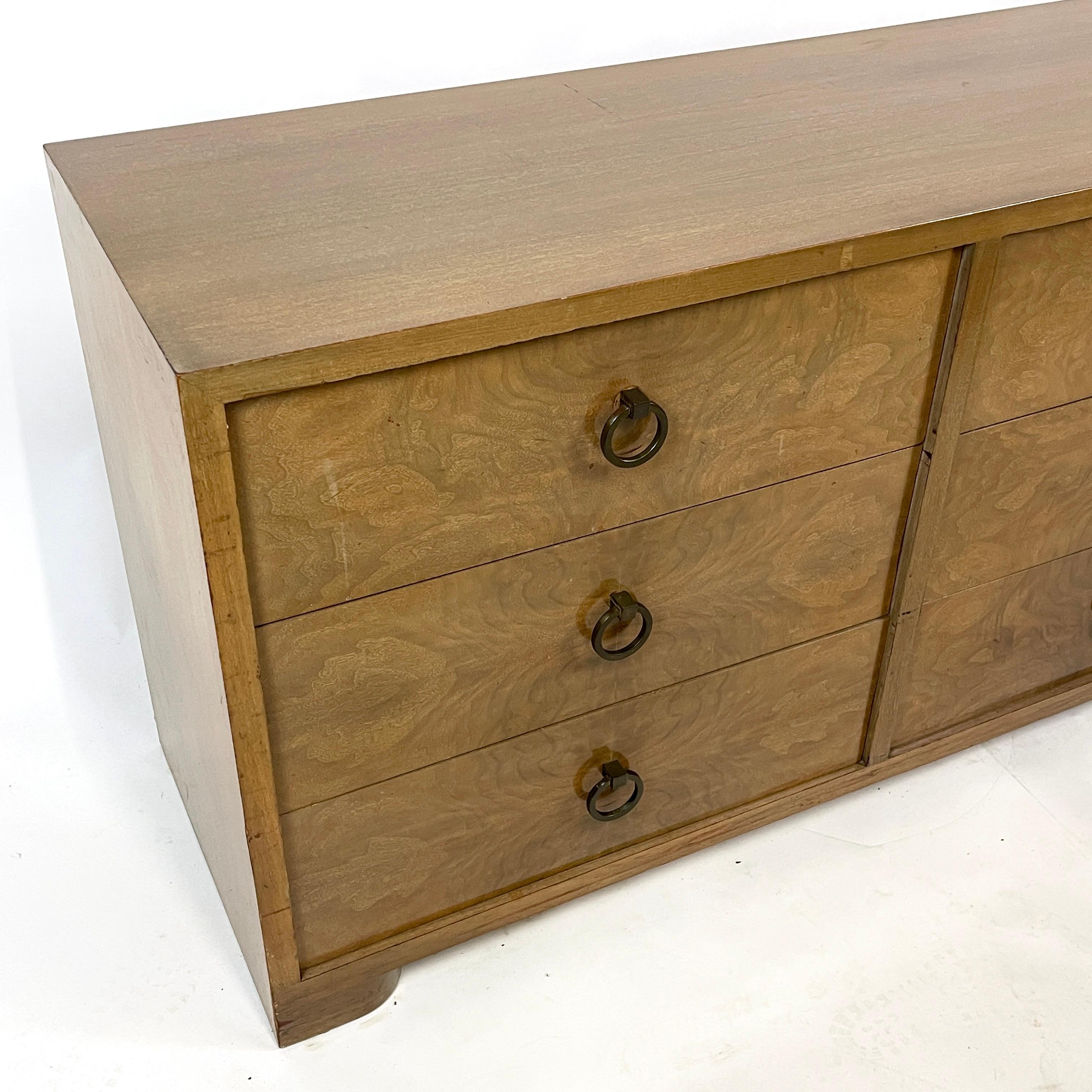 All original 1950s dresser by Red Lion Firniture. Stunning burled mahogany drawer fronts with elegant brass ring pulls. Solid wood with mahogany case. Sculpted feet complete the look of this American Art Deco piece. Glorious rich tones and action