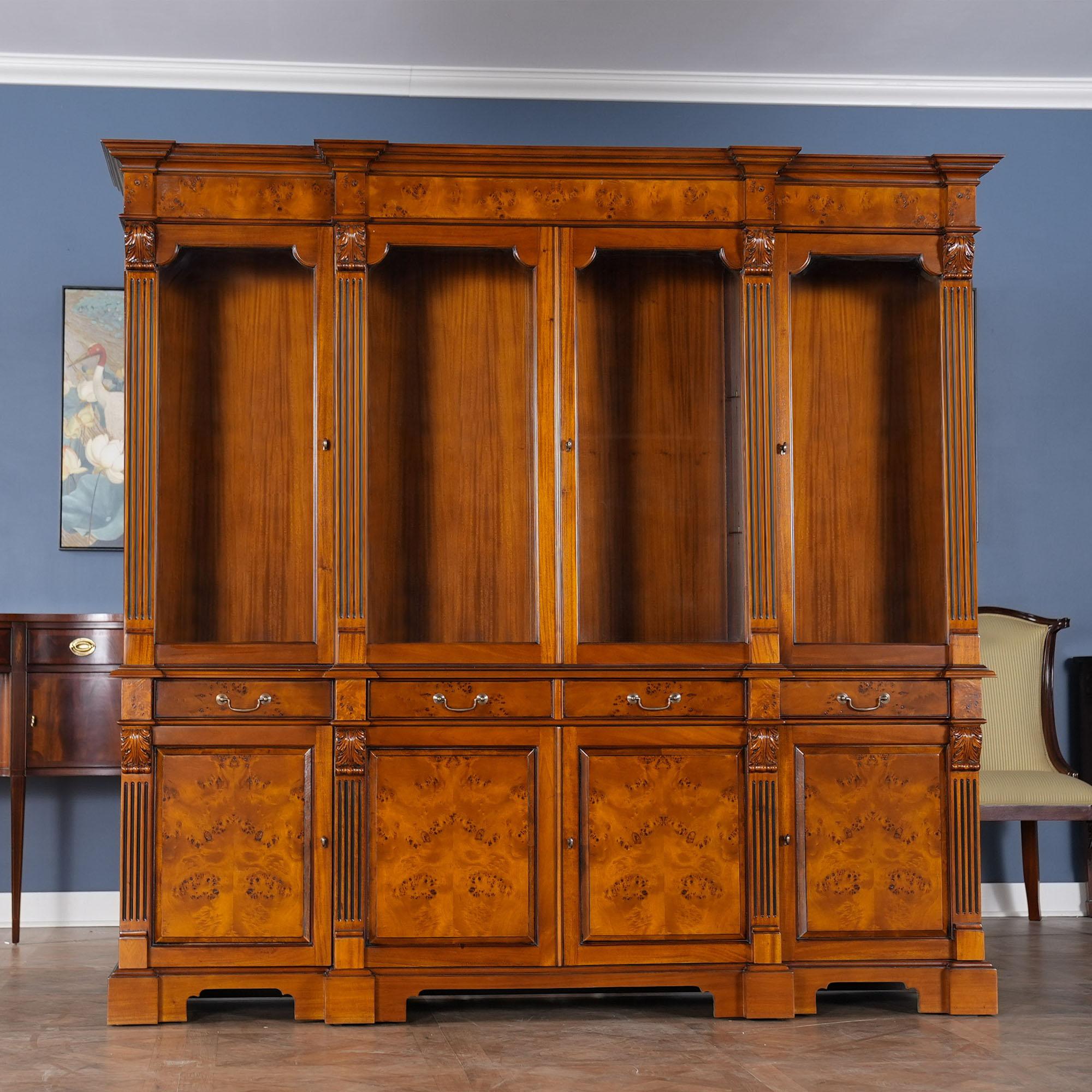 Our Burled Breakfront is manufactured in two sections, the upper section consisting of a deep, molded cornice with burled veneer following the shape of pillars rising from below, with acanthus carved capitals atop four doors with shaped, open glass