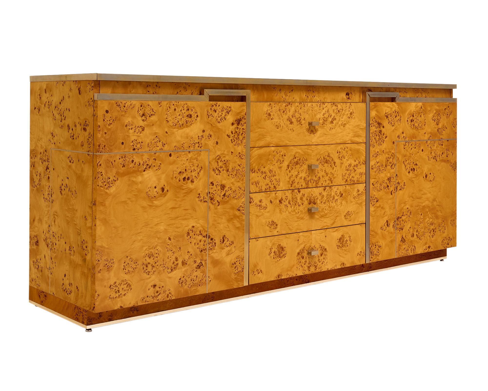 Buffet / Credenza made with a burled elm veneer finish and brass trims throughout. This piece is attributed of Jean-Claude Mahey for Roche Bobois. The back is finished.
