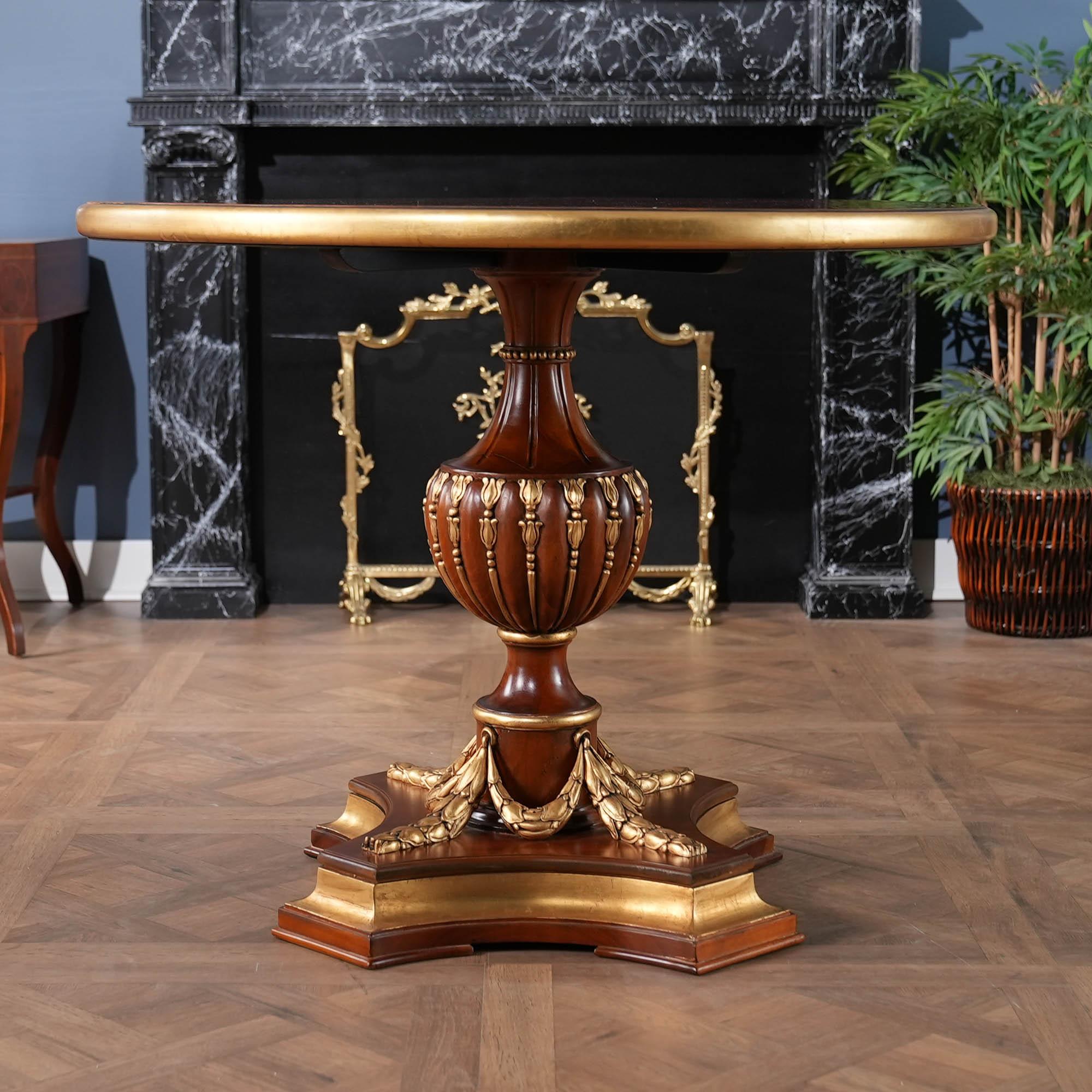 A gorgeous, high quality Burled Center Table  from Niagara Furniture with plenty of presence to brighten up any room. Banded and burled top, hand carved solid mahogany base and real gold leaf accents all work together to create a table that could be