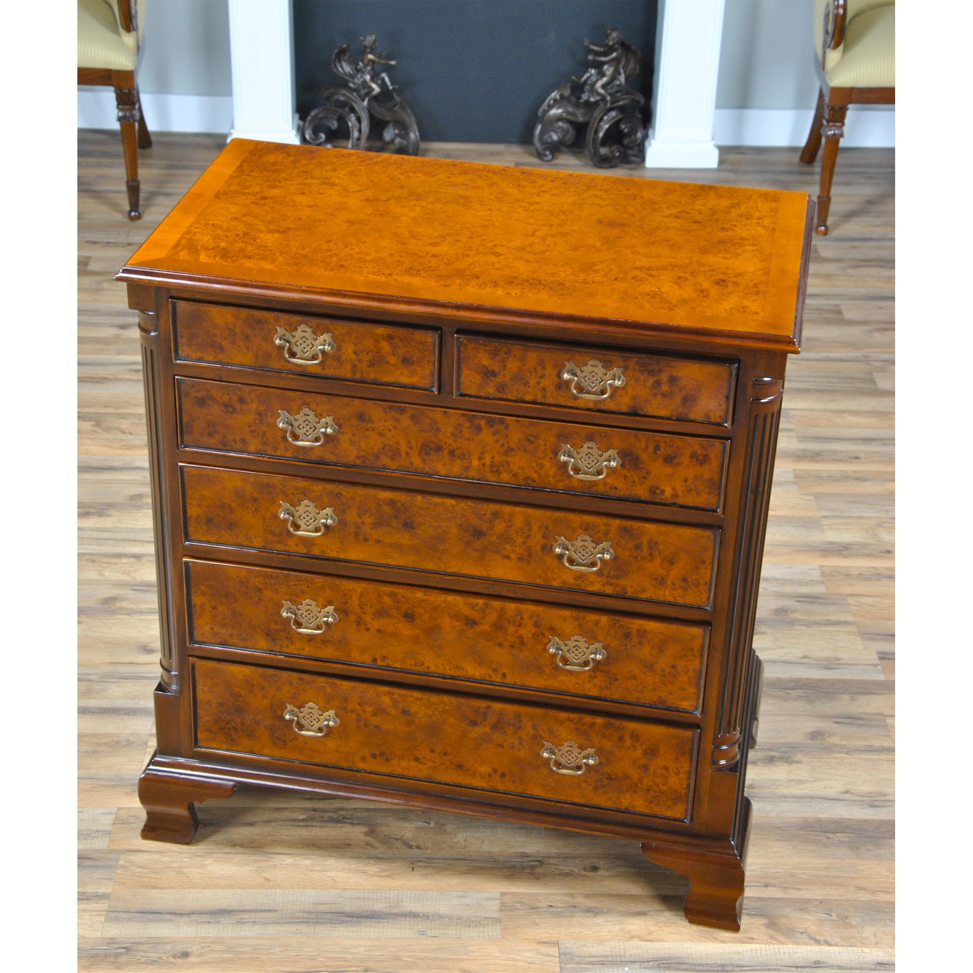 This elegant antique reproduction Burled Chest has superb detailing with bead molding around its four graduated drawers and two uppermost drawers, graceful solid brass escutcheons and drawer pulls, delicately fluted quarter columns and well