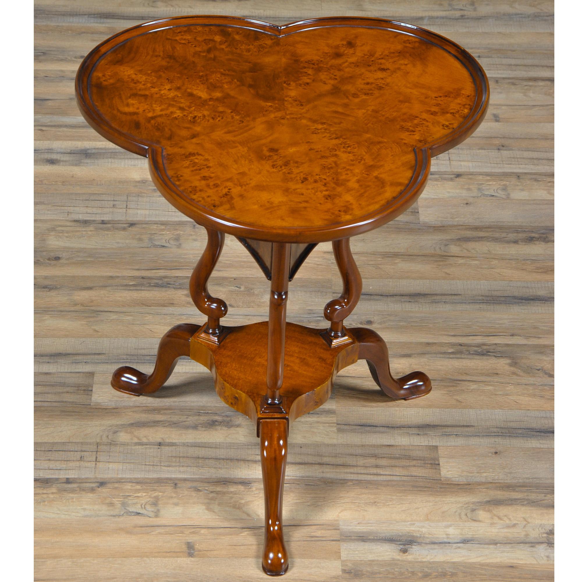 A high quality, clover top shaped Burled Clover Table produced by Niagara Furniture. Also traditionally referred to as a wine table. Beautifully shaped and presented top, supported by curved and shaped supports and resting on three solid mahogany