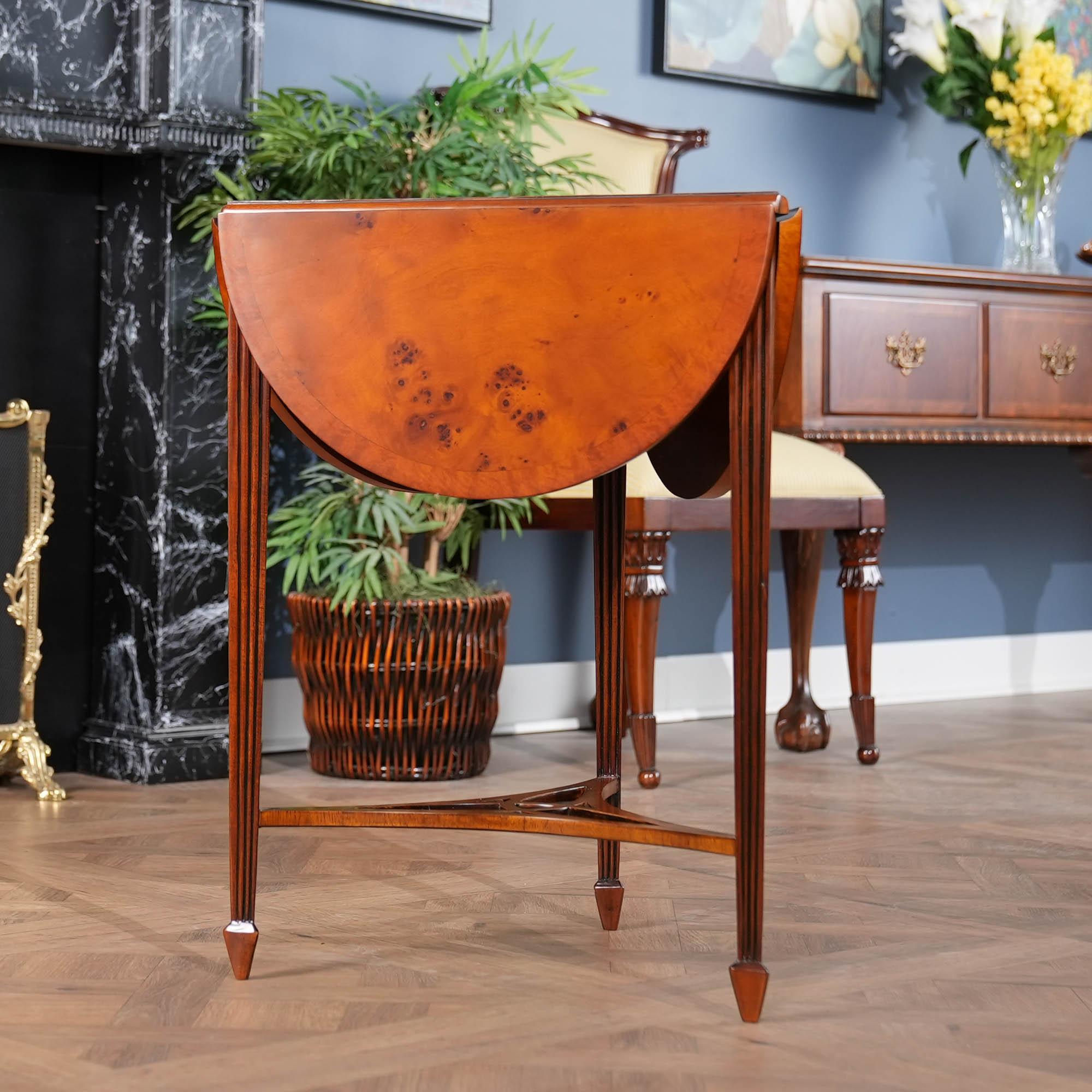 This  three leg or tripod Burled Handkerchief Table closes to small triangular size when the leaves are not in use and opens to a beautiful clover shaped table when they are opened. Beautiful burled veneers create striking patterns on the top and