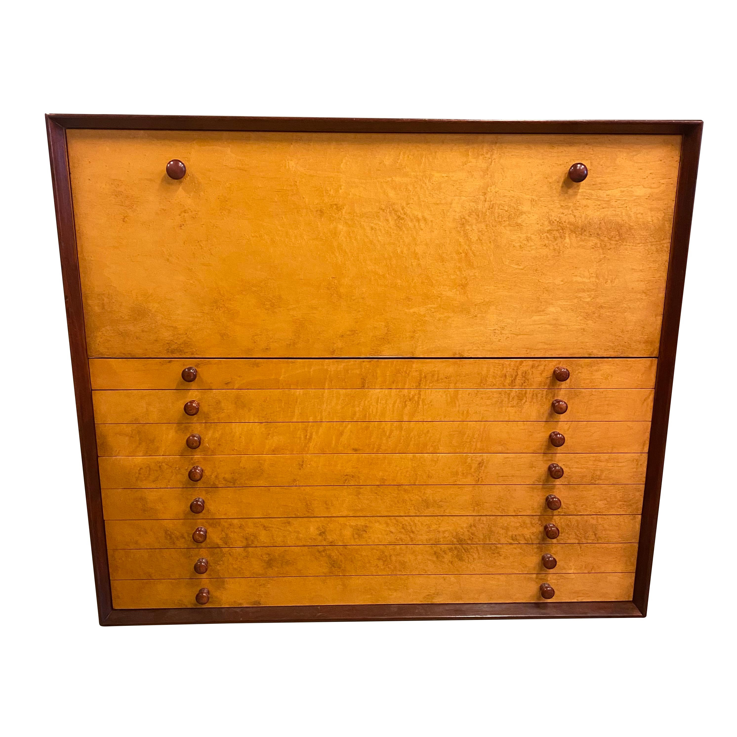 Edward Wormley style Mid-Century Modern case piece with drawers at base and drop-down secretary at top. Two toned finish that appears to be rosewood and burled maple. Interior of desk is fitted with multiple small drawers and cubbies, like an