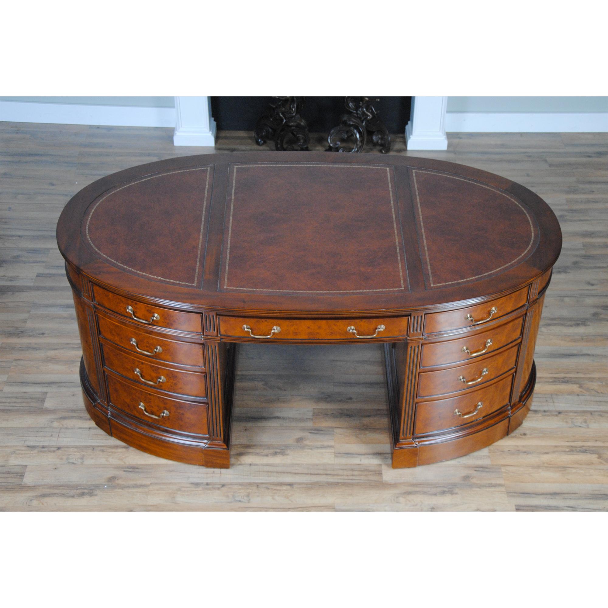 One of the most complicated items that we produce at Niagara furniture our Burled Oval Partners Desk is also one of the most popular. The top section of the desk consists of a three-paneled writing surfaces of brown full grain genuine leather which