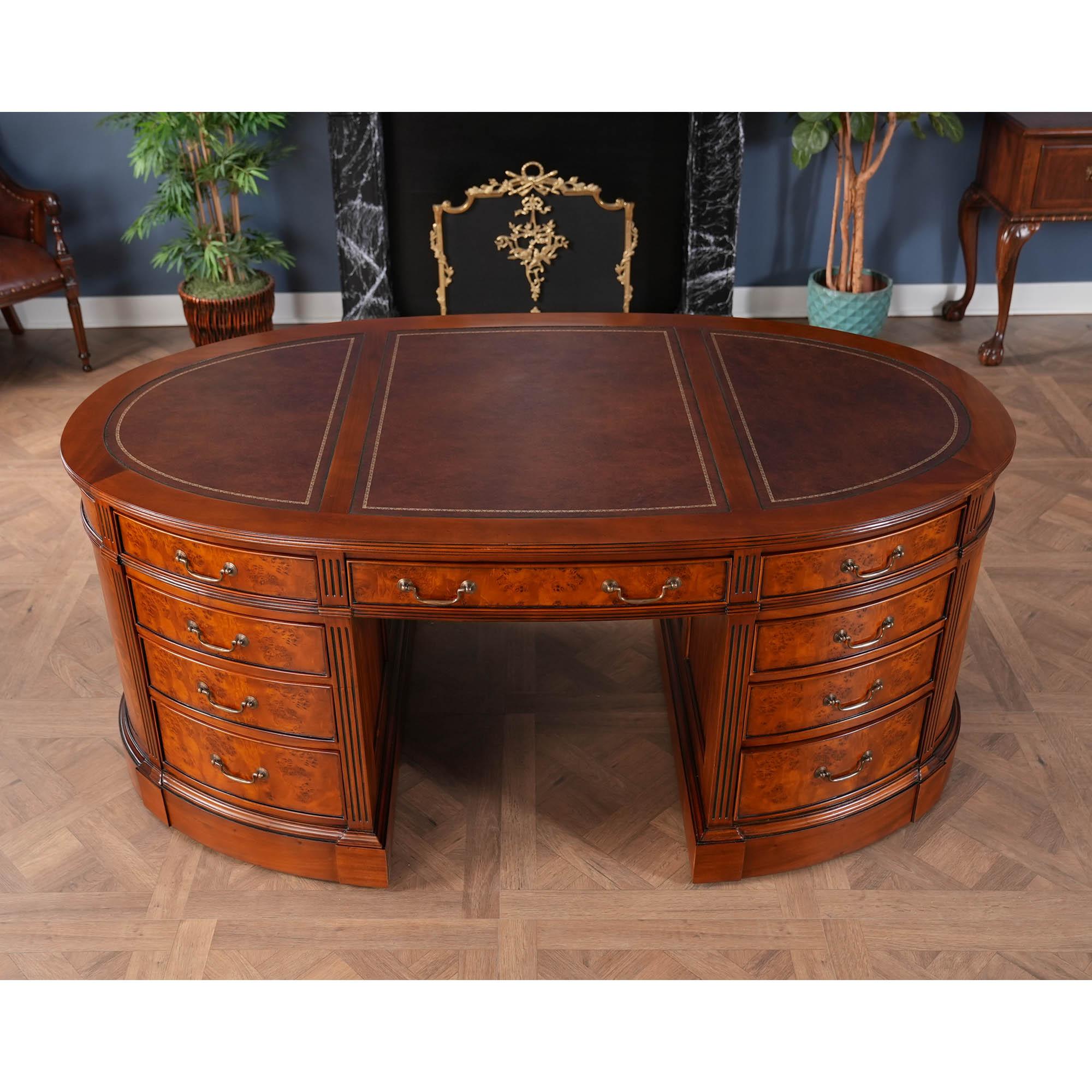 One of the most complicated items that we produce at Niagara furniture our Burled Oval Partners Desk is also one of the most popular. The top section of the desk consists of a three-paneled writing surfaces of brown full grain genuine leather which