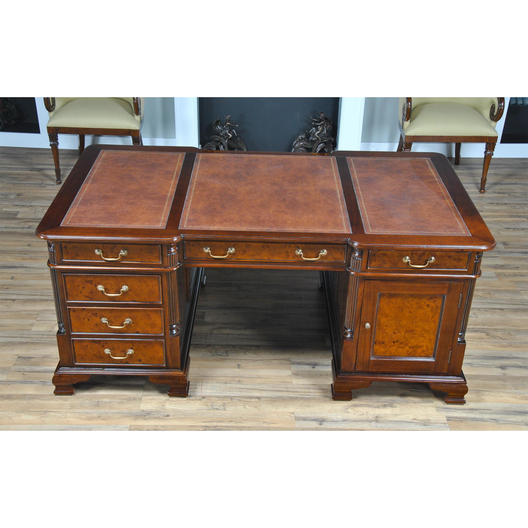 This beautiful burled partners desk by Niagara Furniture is crafted as an antique reproduction. The fine quality veneers in the drawer and door panels displays a rich color similar to that found in English antiques. The three-paneled writing surface
