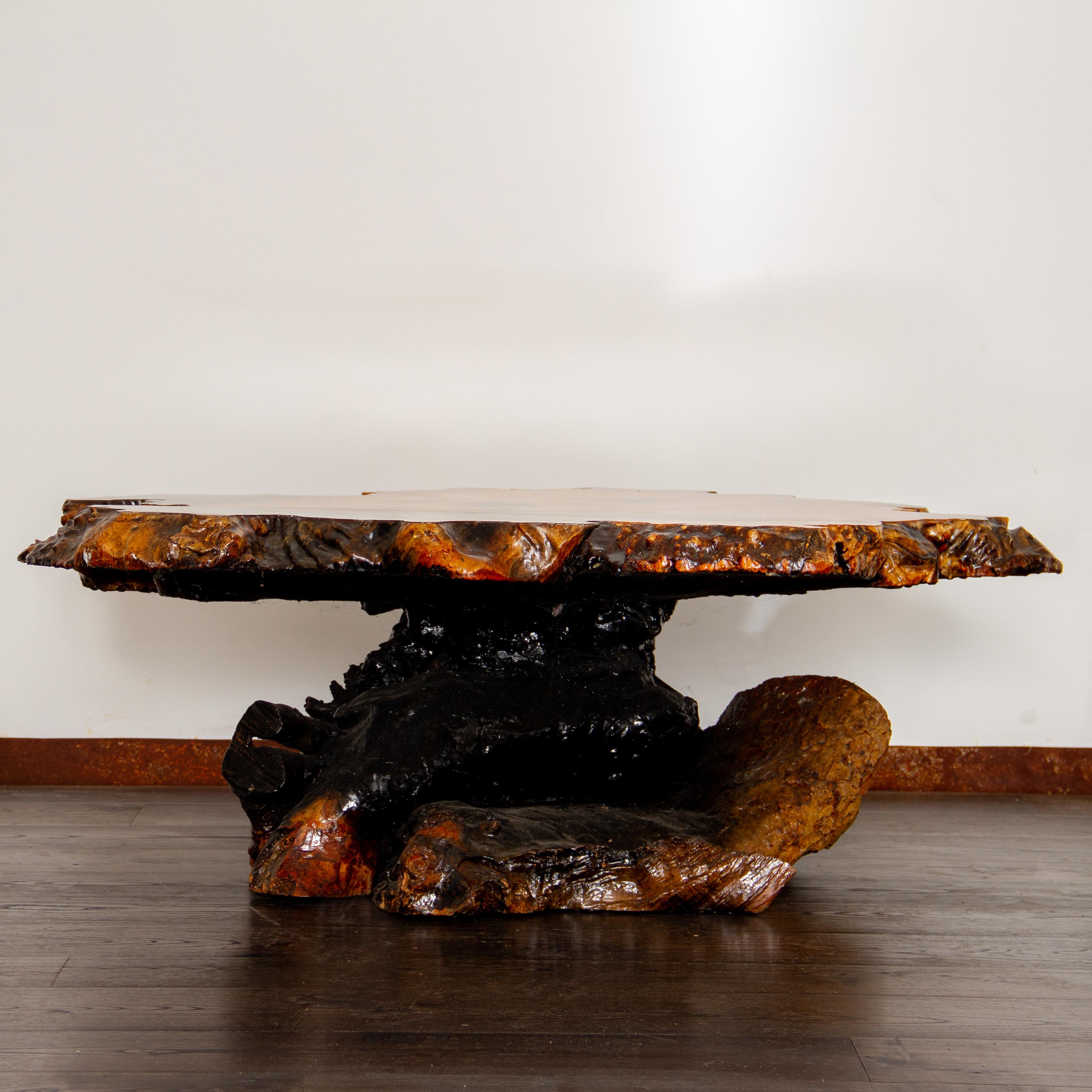An exotic, natural burled root coffee table under a resin finish. This root table has a great texture and is unlike any other coffee table due to its live edge and knots, circa 1960s. Light scratches to the resin top.