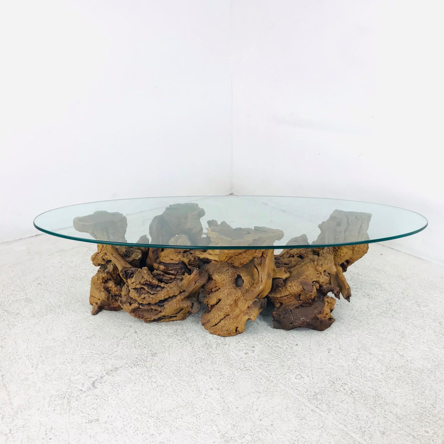 Unique sculptural burled root coffee table with glass top.